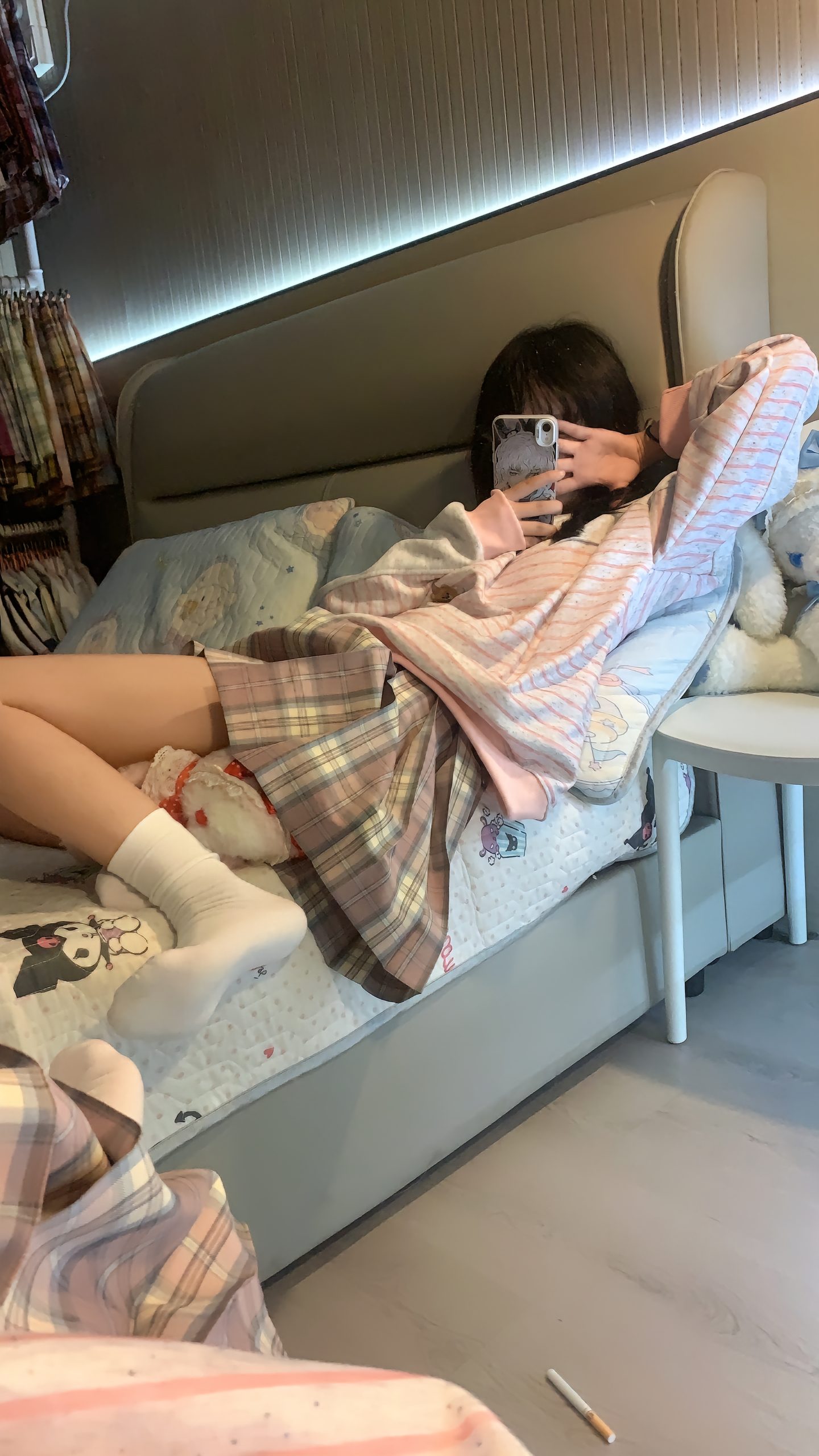 女孩躺在床上,看着她的手机。