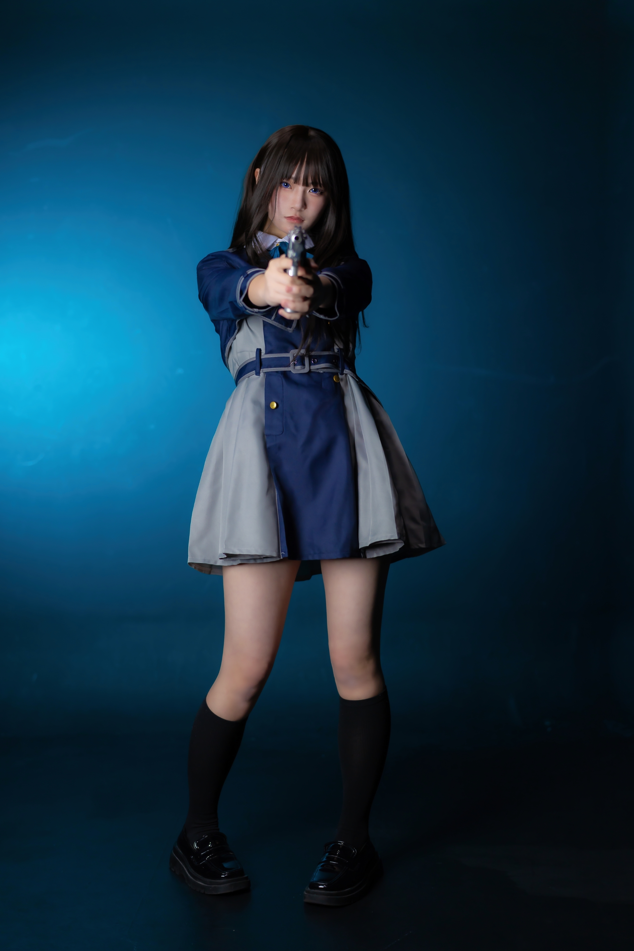 穿着蓝色衣服的女人拿着一把枪。