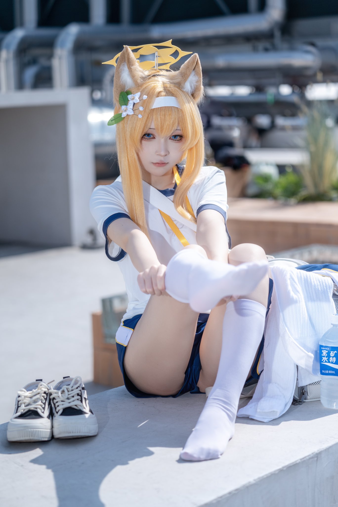 穿着白色衬衫和白袜子的女人坐在桌子上。