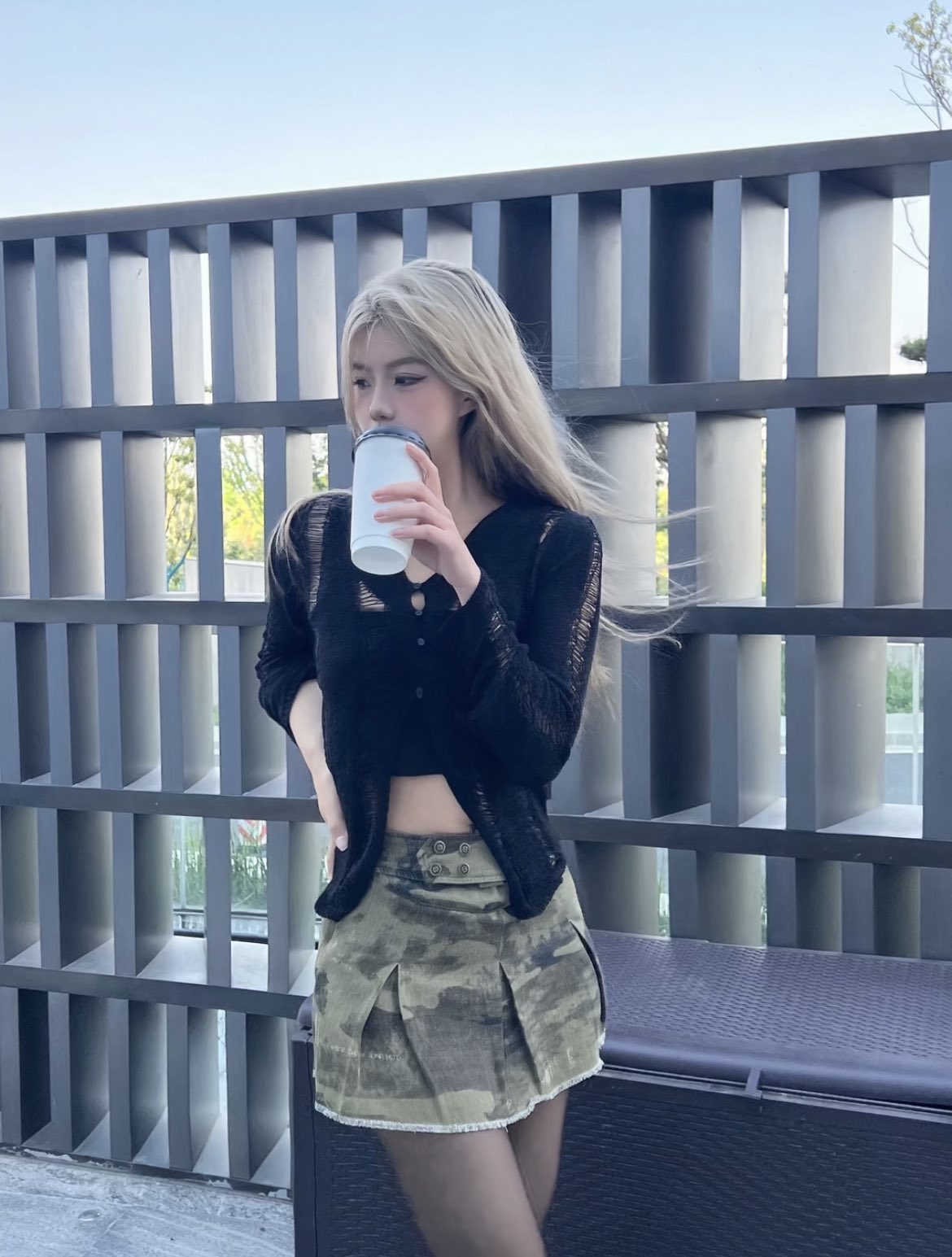 女人从杯子里喝。