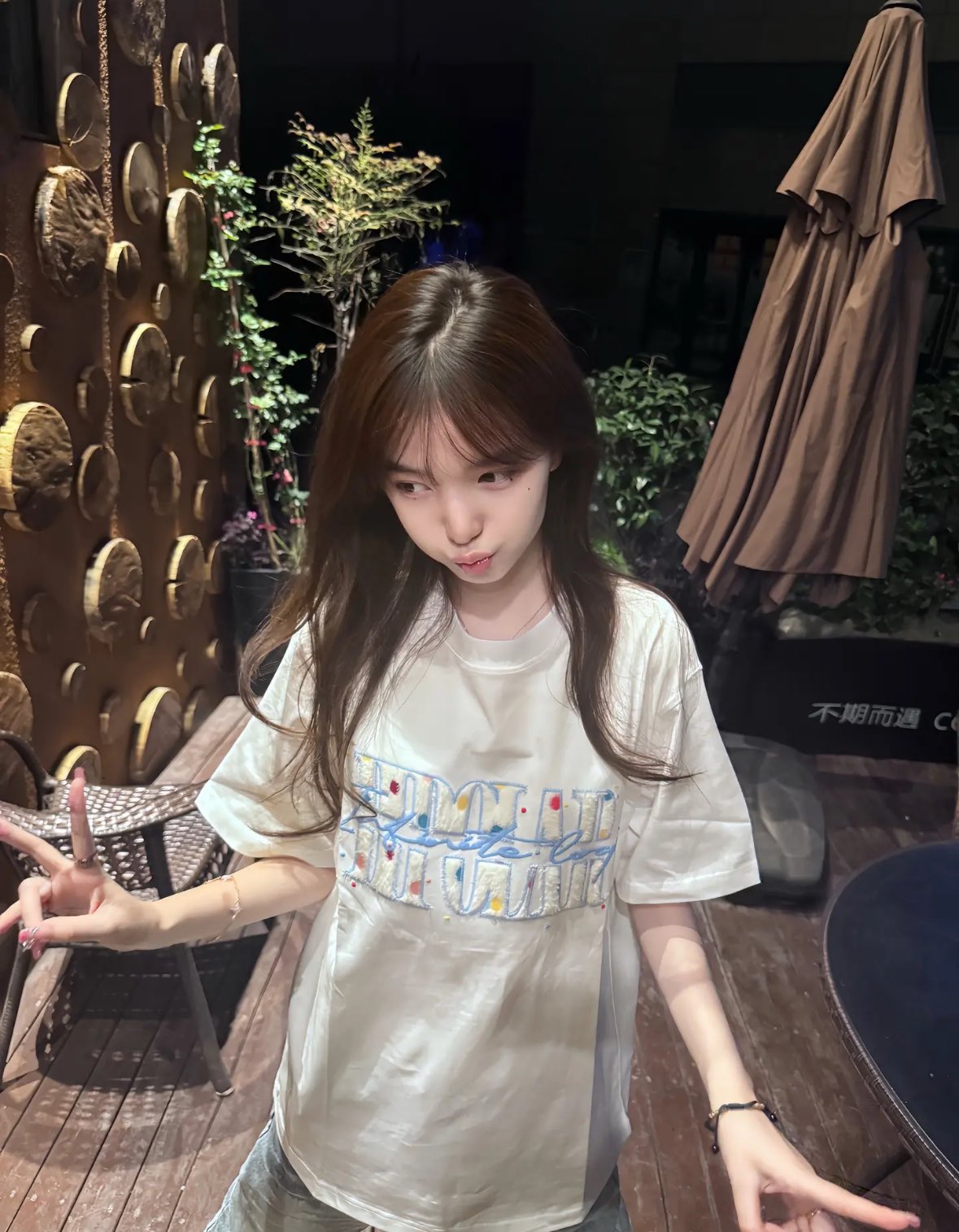 女人穿着一件白色衬衫,上面有一杯咖啡。