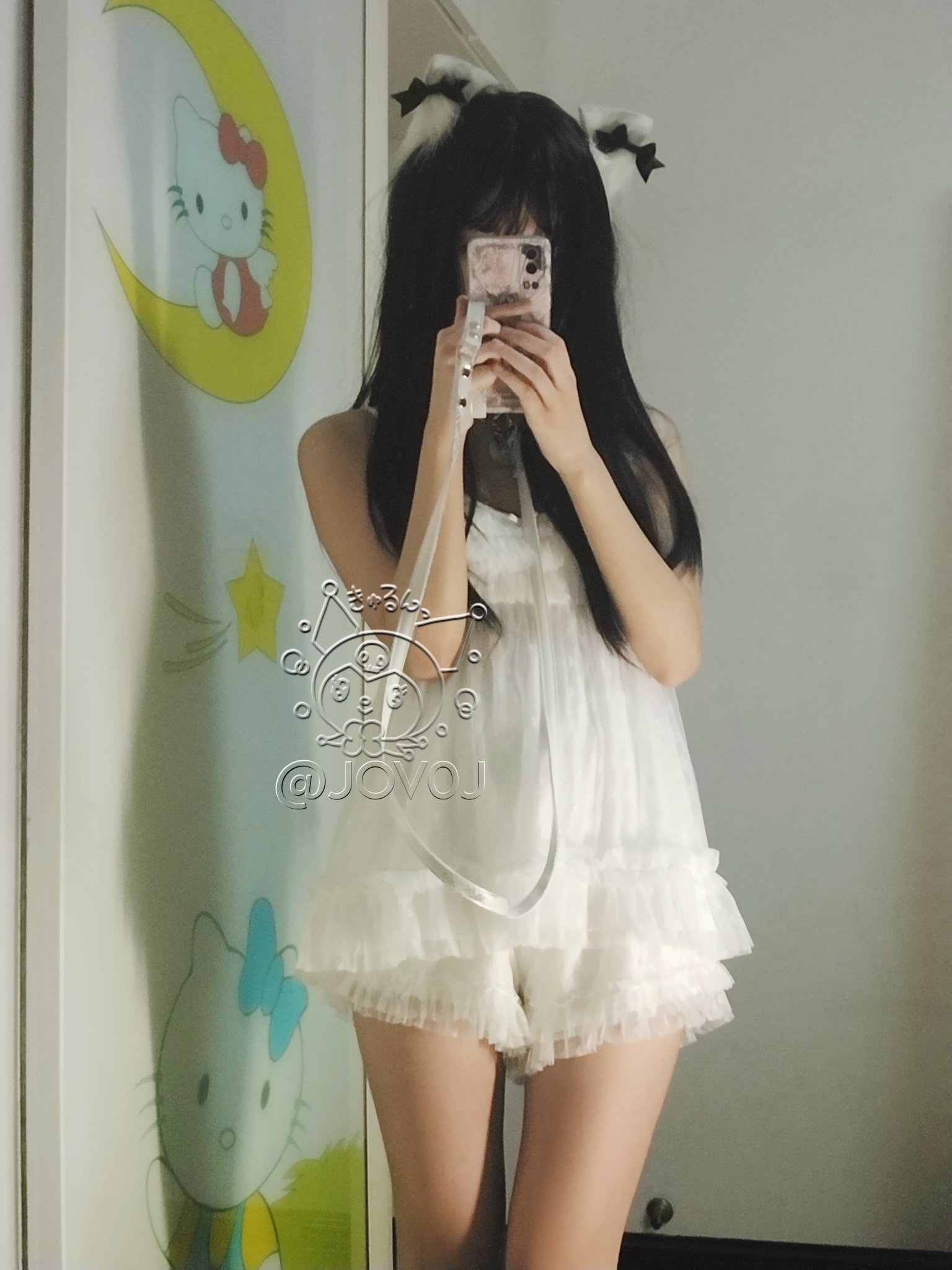 女孩在Hello Kitty的照片前拍自拍。