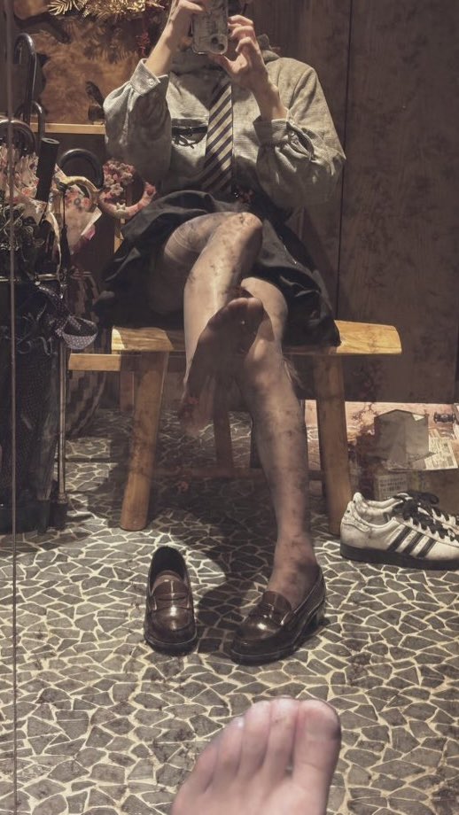 女人坐在椅子上,脚抬起来。