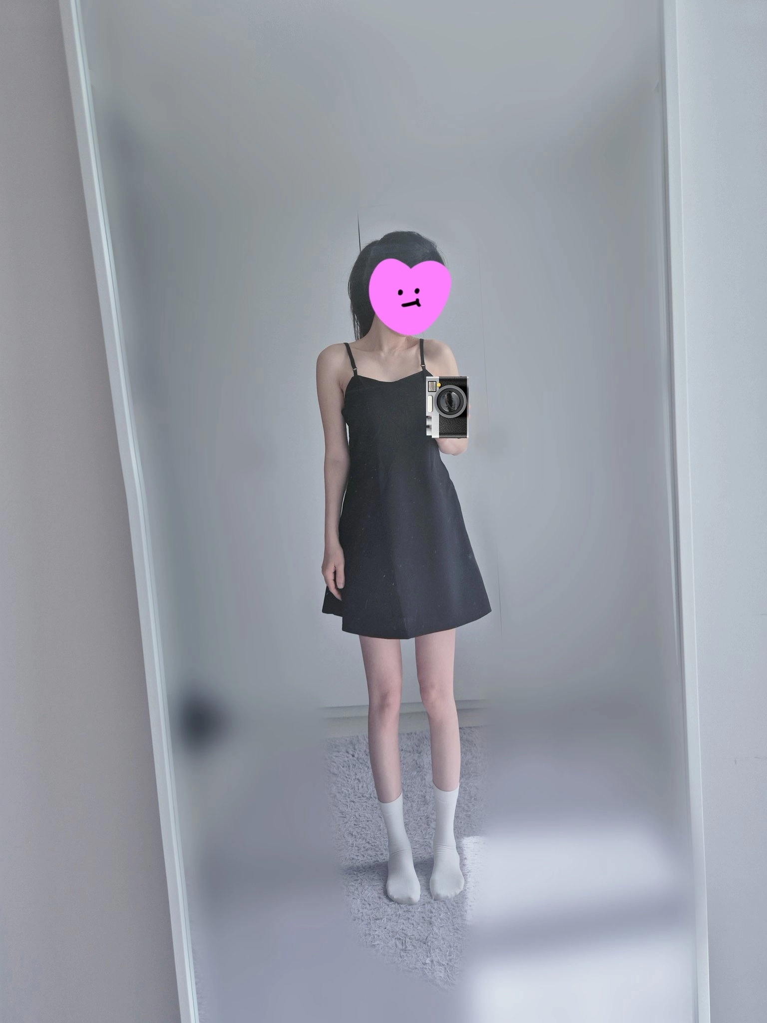 一位穿着黑色裙子和白色袜子的女人拍了一张自拍。