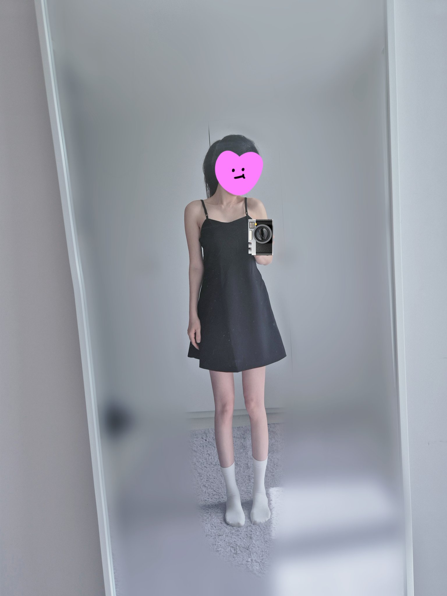 一位穿着黑色裙子和白色袜子的女人拍了一张自拍。