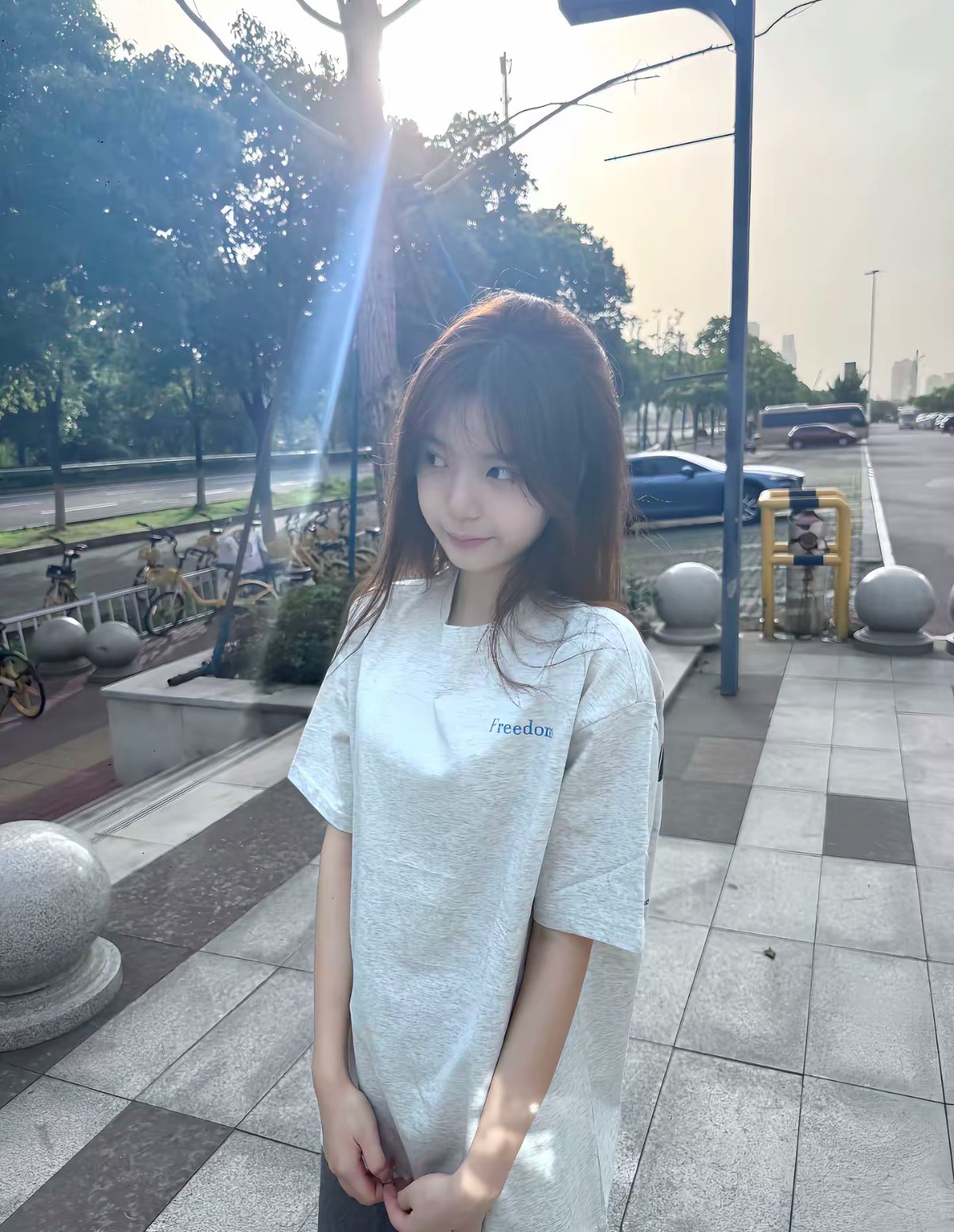 一位戴着马尾巴和一件白色衬衫的女人站在通道上。