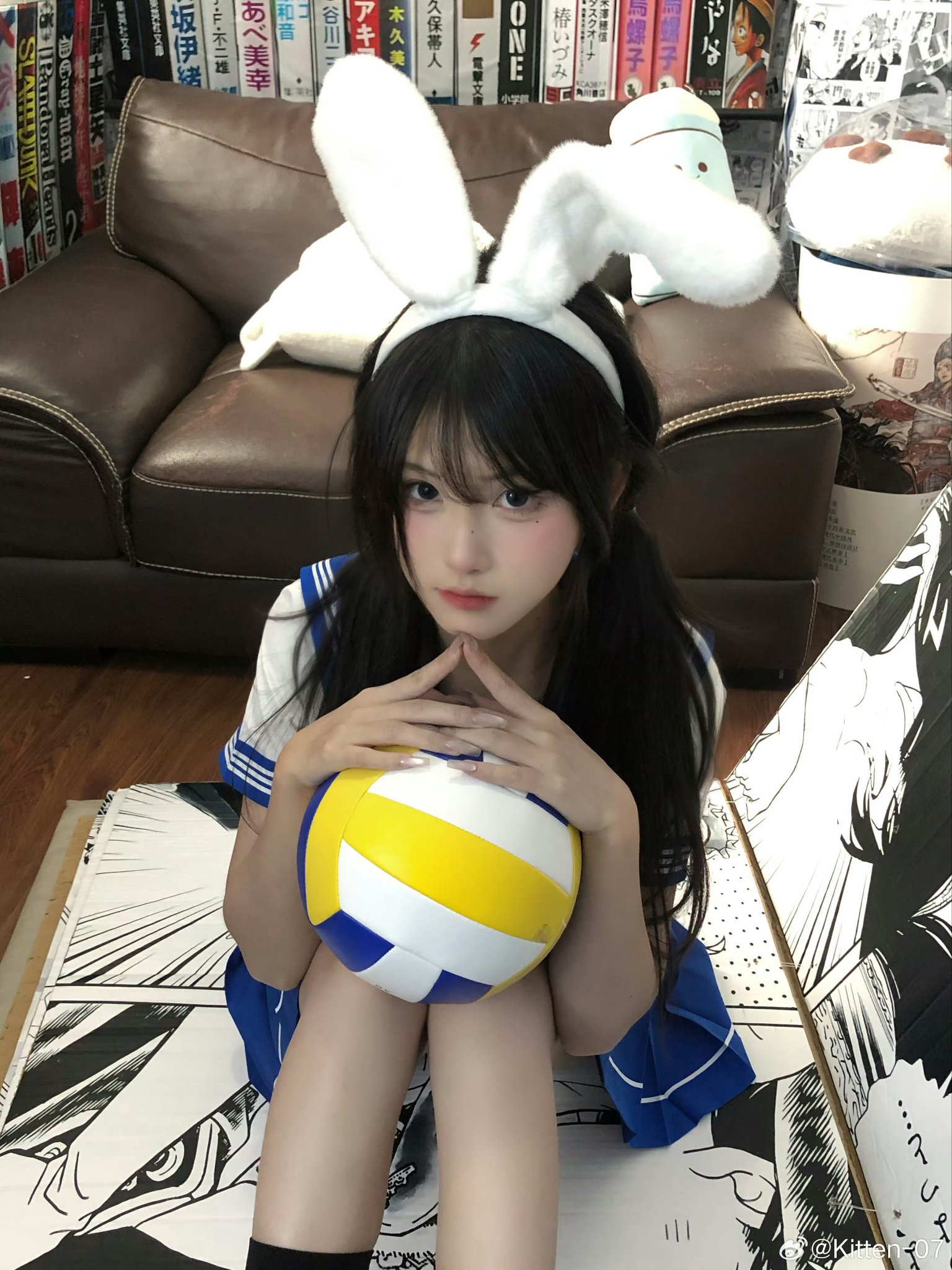 穿兔子服的女孩拿着一颗黄色的球。