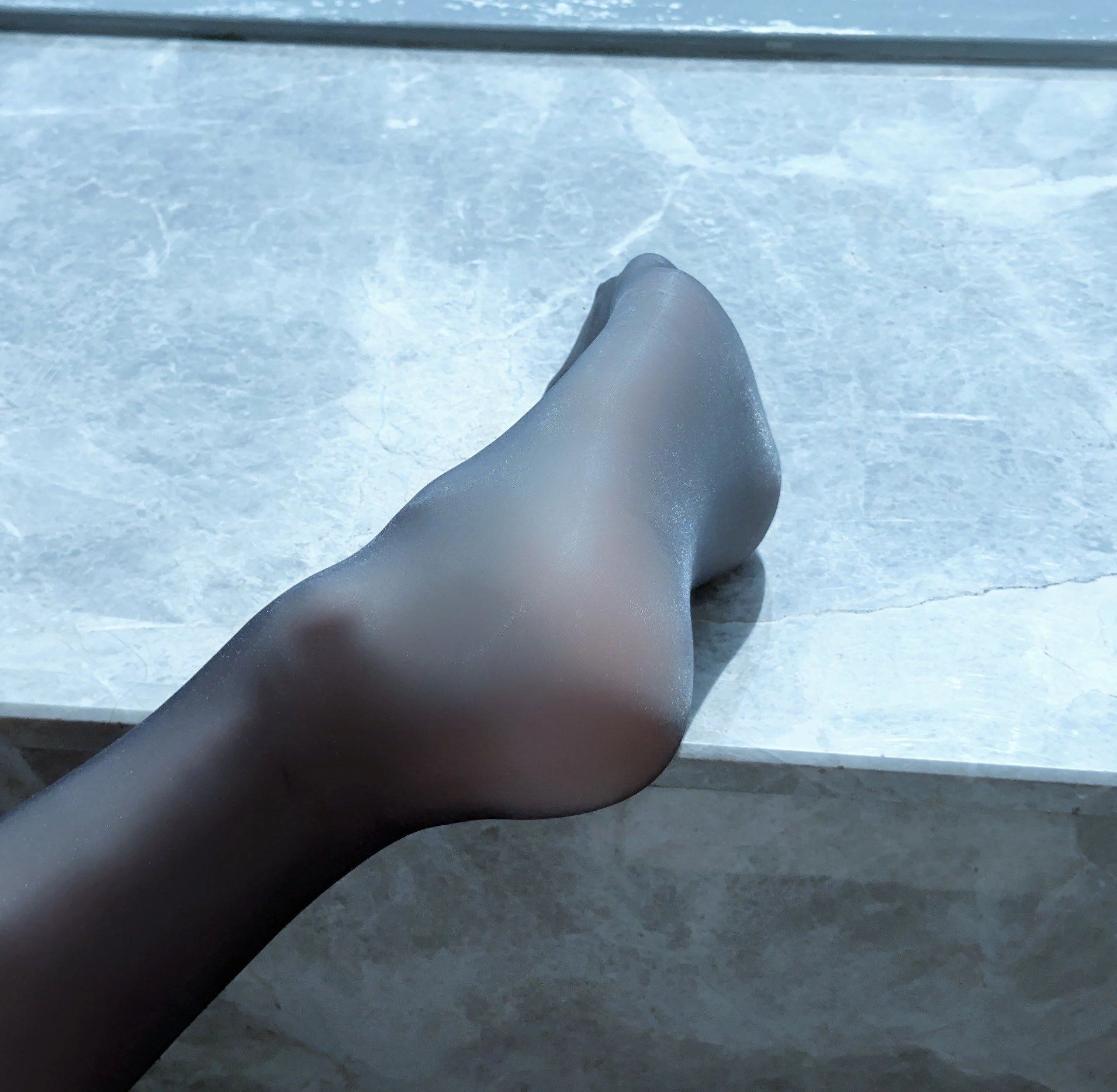 女人的脚在大理石柜台上。