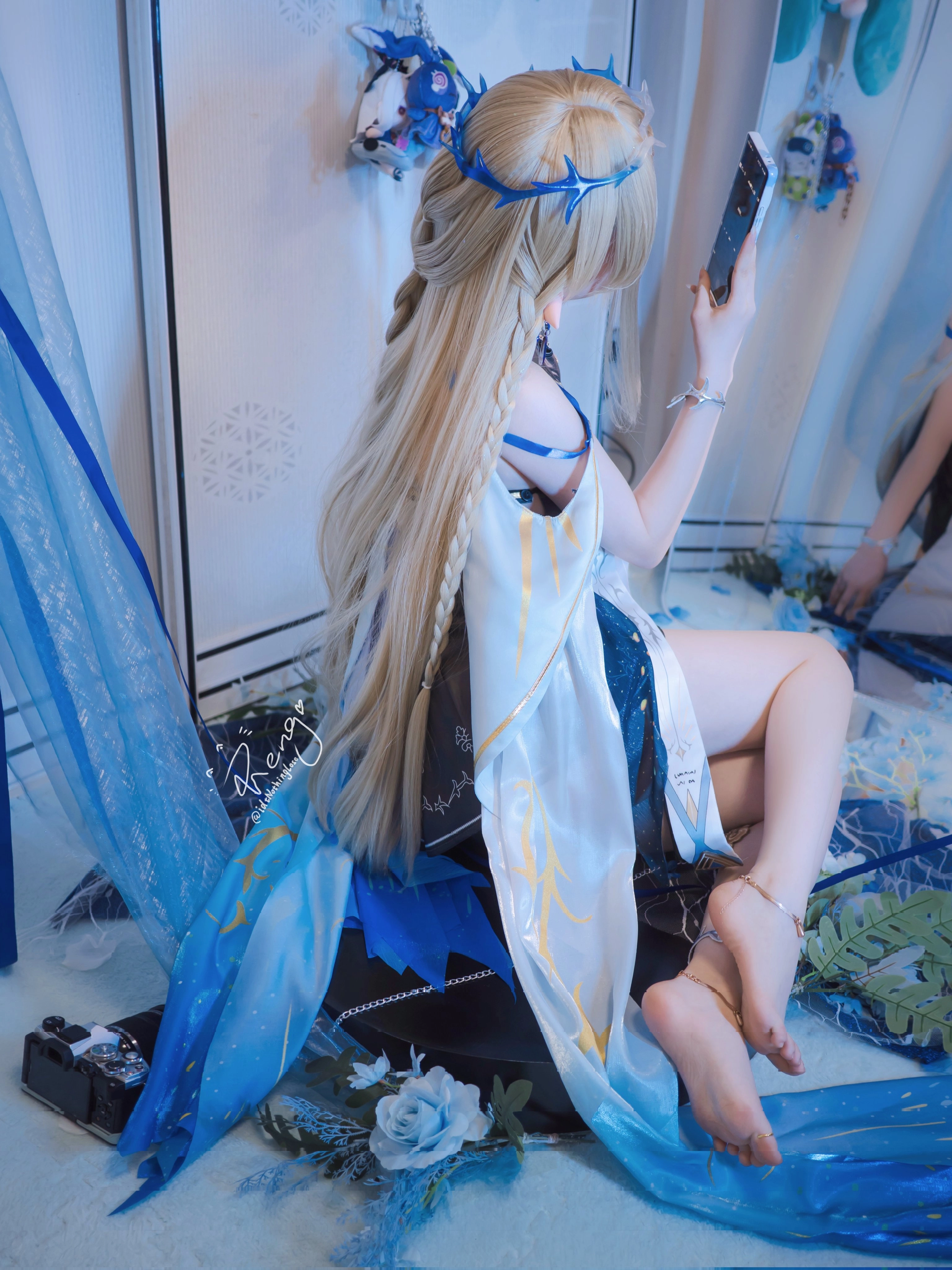 穿着白色和蓝色衣服的女人坐在地板上。