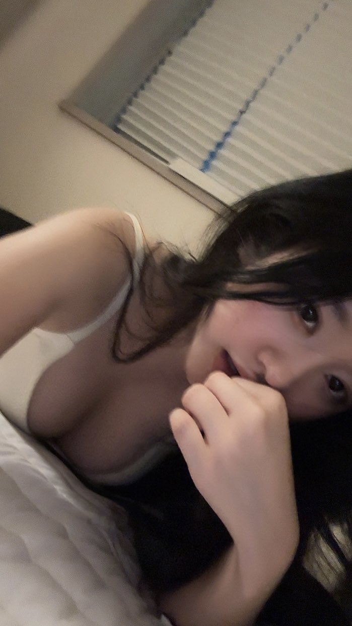 穿着白色衬衫和黑色头发的女人正在躺下。