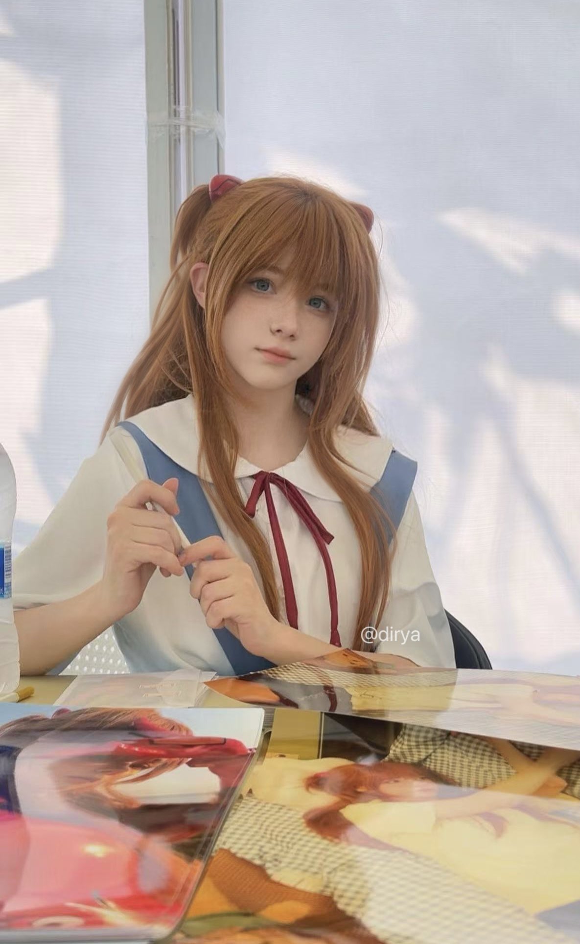 长头发和蓝弓的女孩在一张纸上写信。