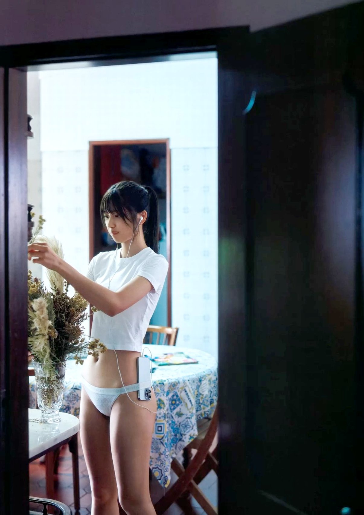 女人在窗前刷牙。