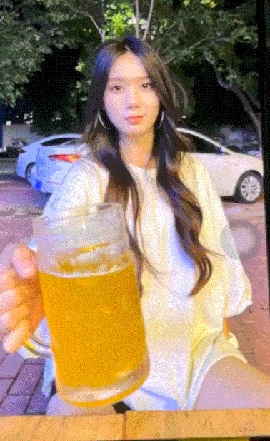 女人拿着一杯啤酒。