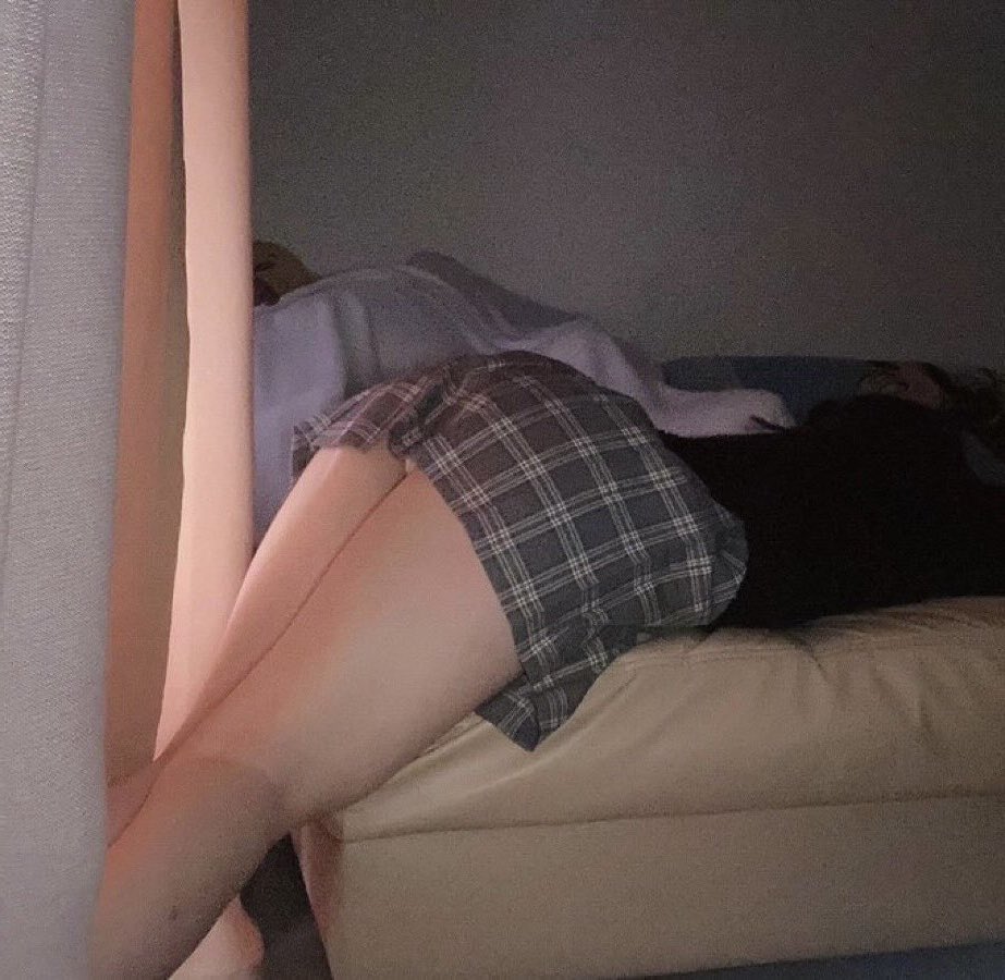 女人躺在沙发上,腿抬起来。