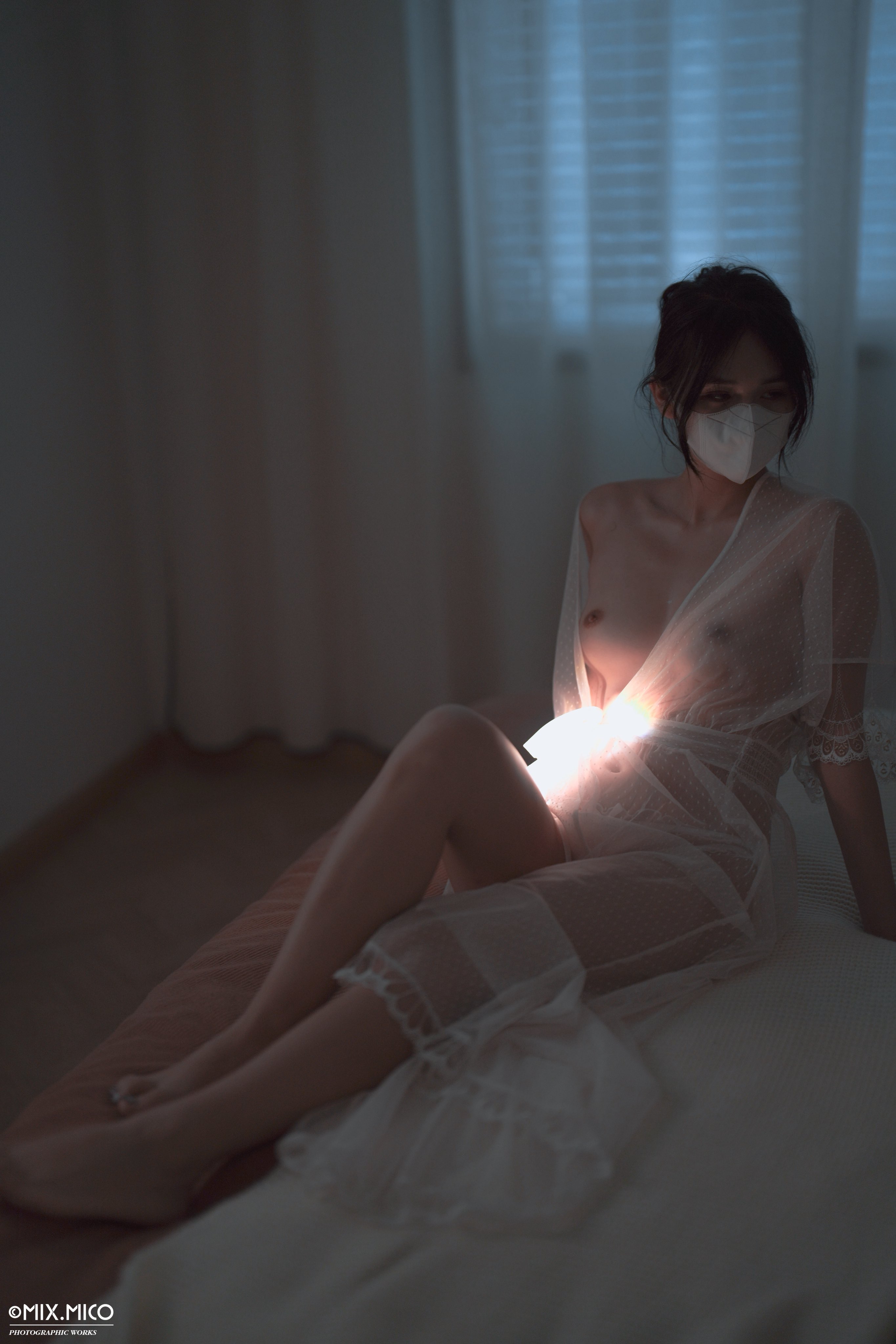 女人戴着面具和一件白色的衣服。