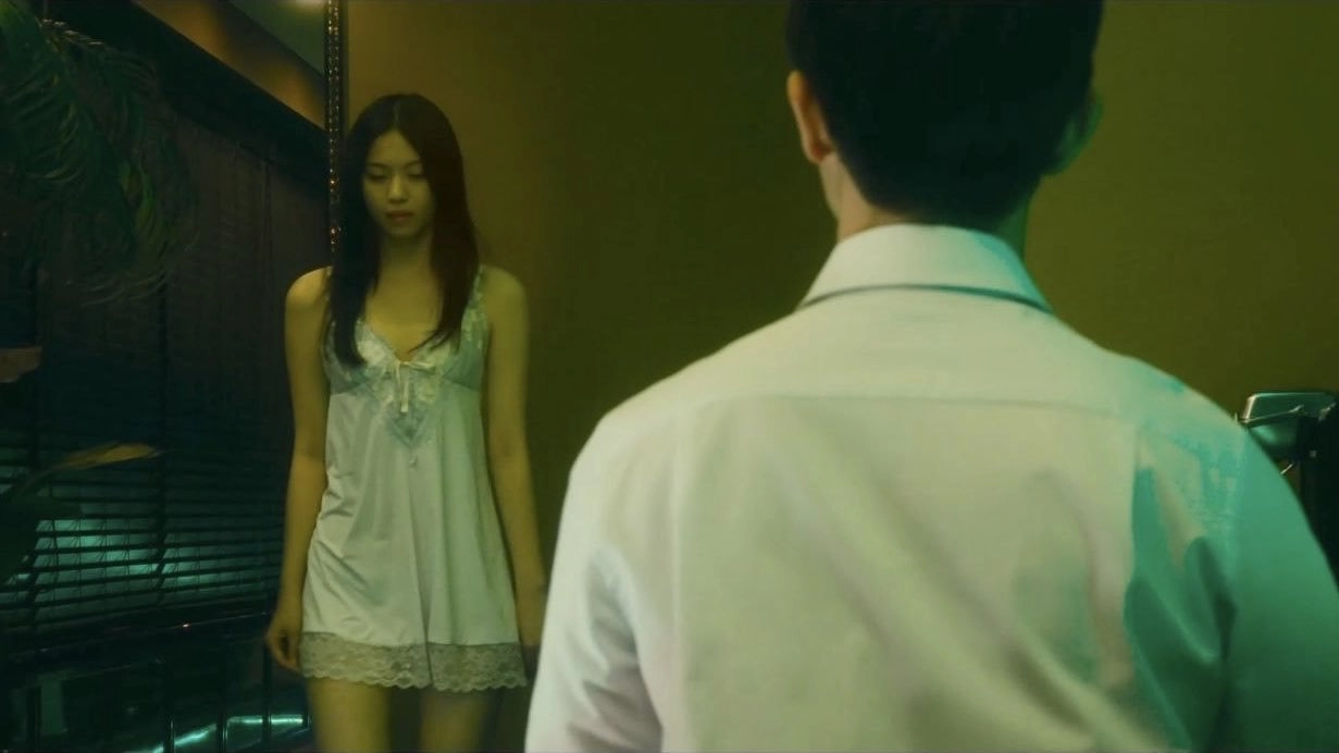 穿着白色衣服的女人在镜子里看着她的反射。