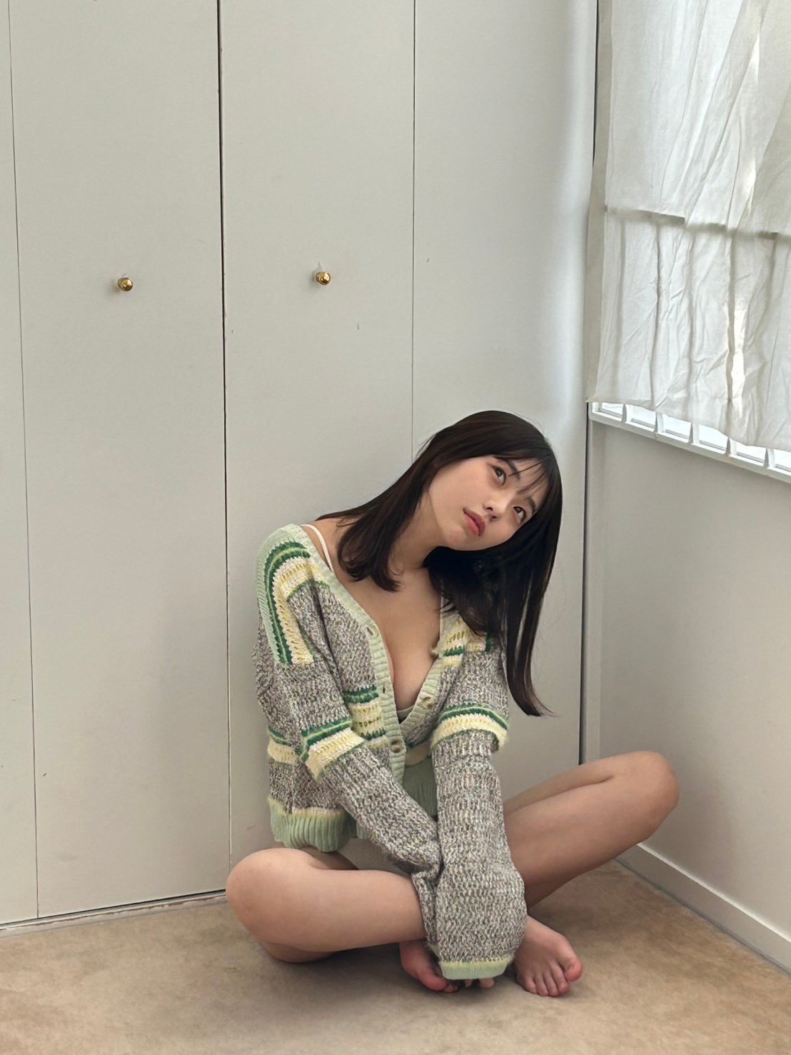 穿着灰色衬衫的女人躺在床上。