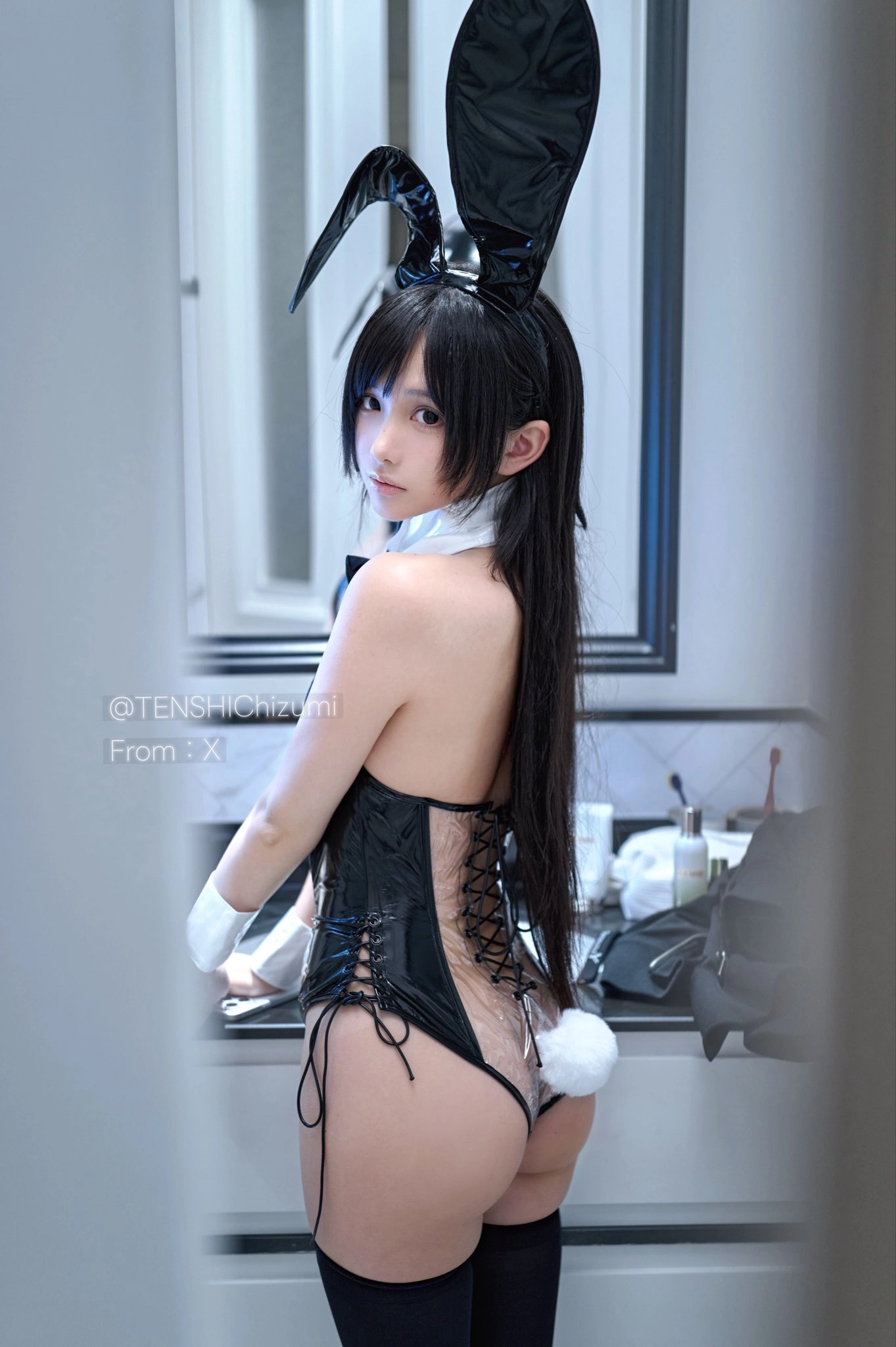 女人穿着兔子服装和兔子耳朵。