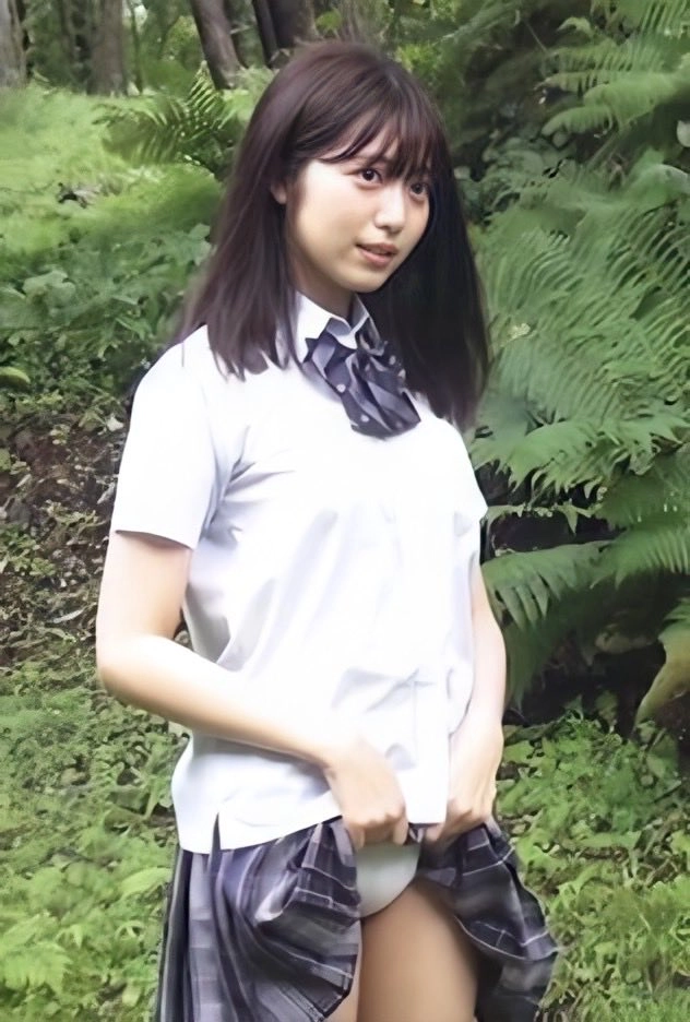 一位穿着白色衬衫和领带的女人站在绿色背景前面。