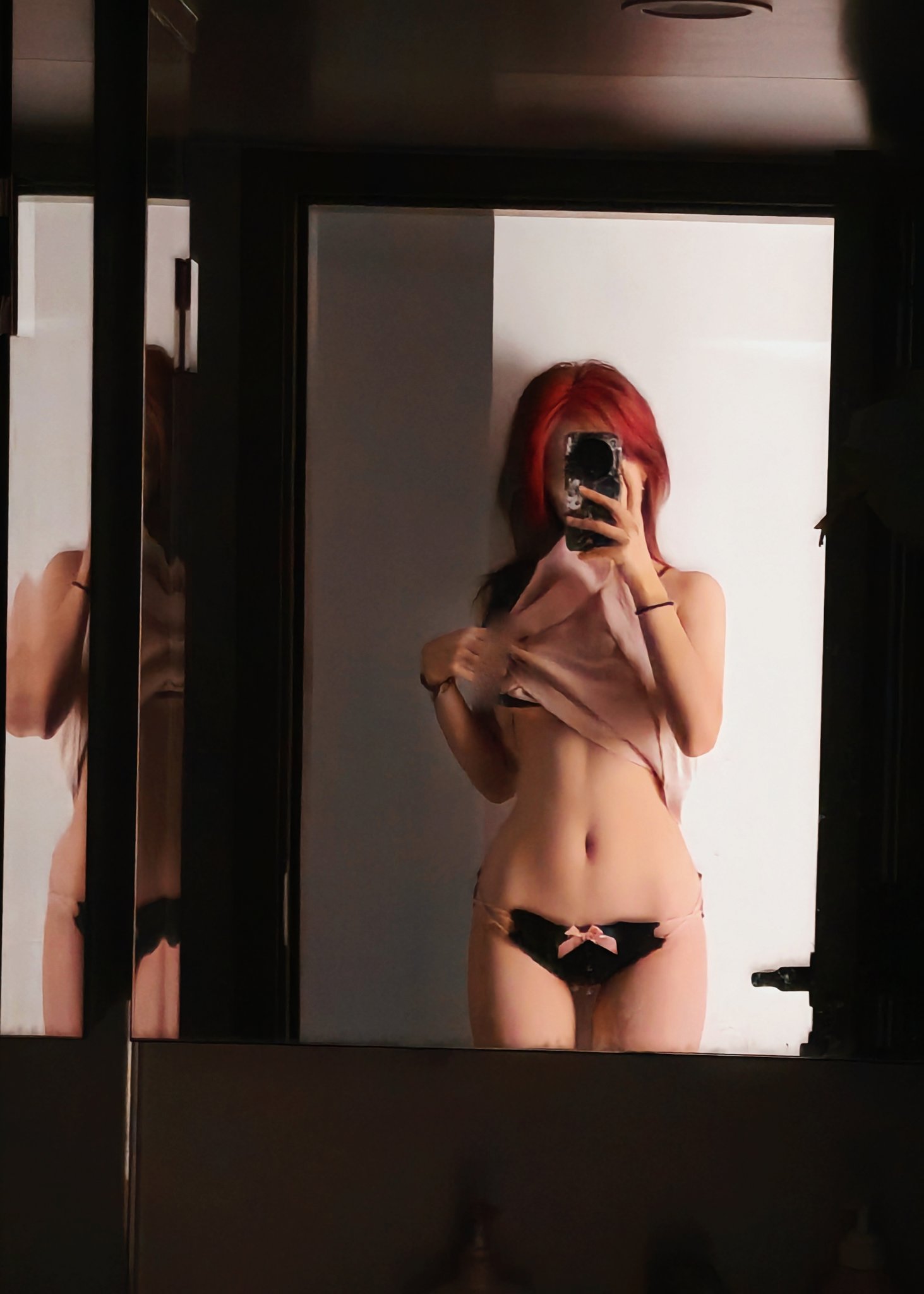 女人在镜子里拍自拍。