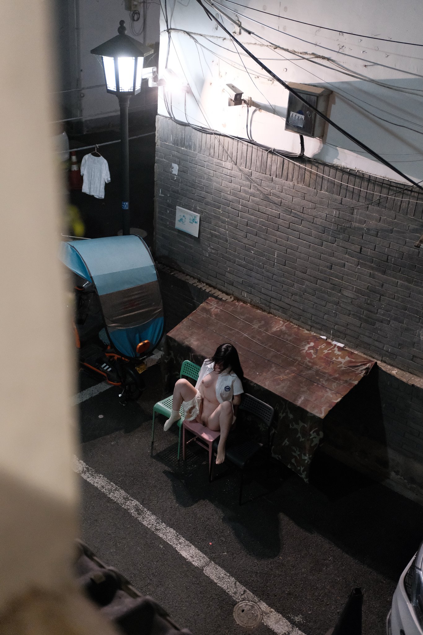 女人坐在外面的椅子上。