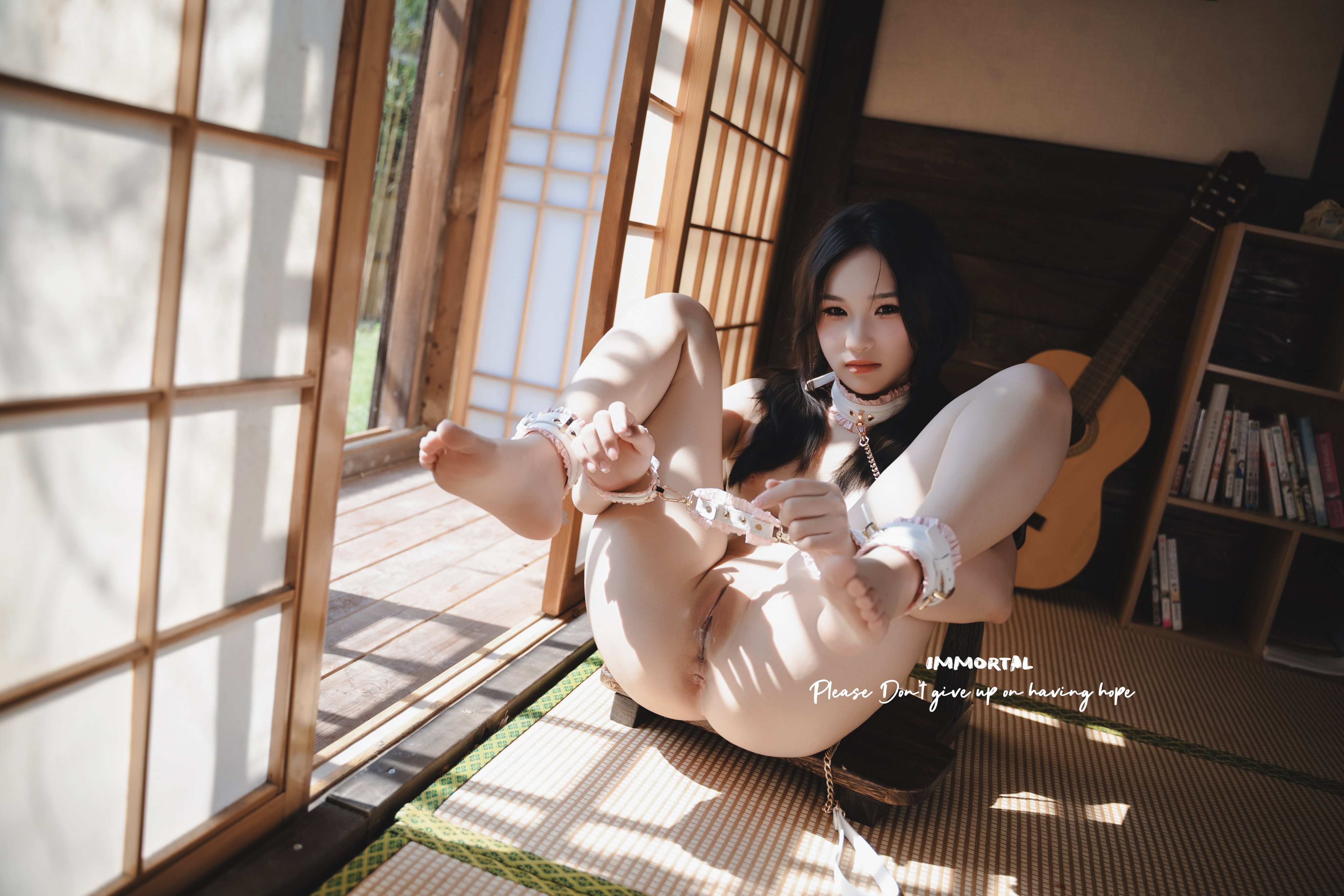 女人戴着项链,拿着吉他。