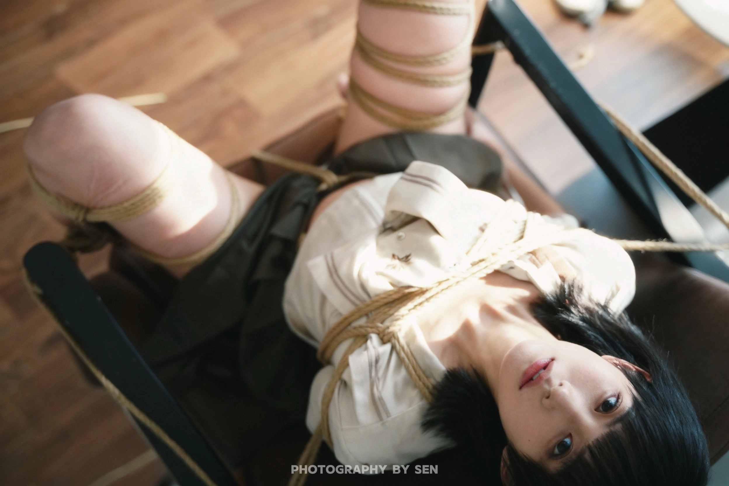 女人被綁起來,坐在椅子上。