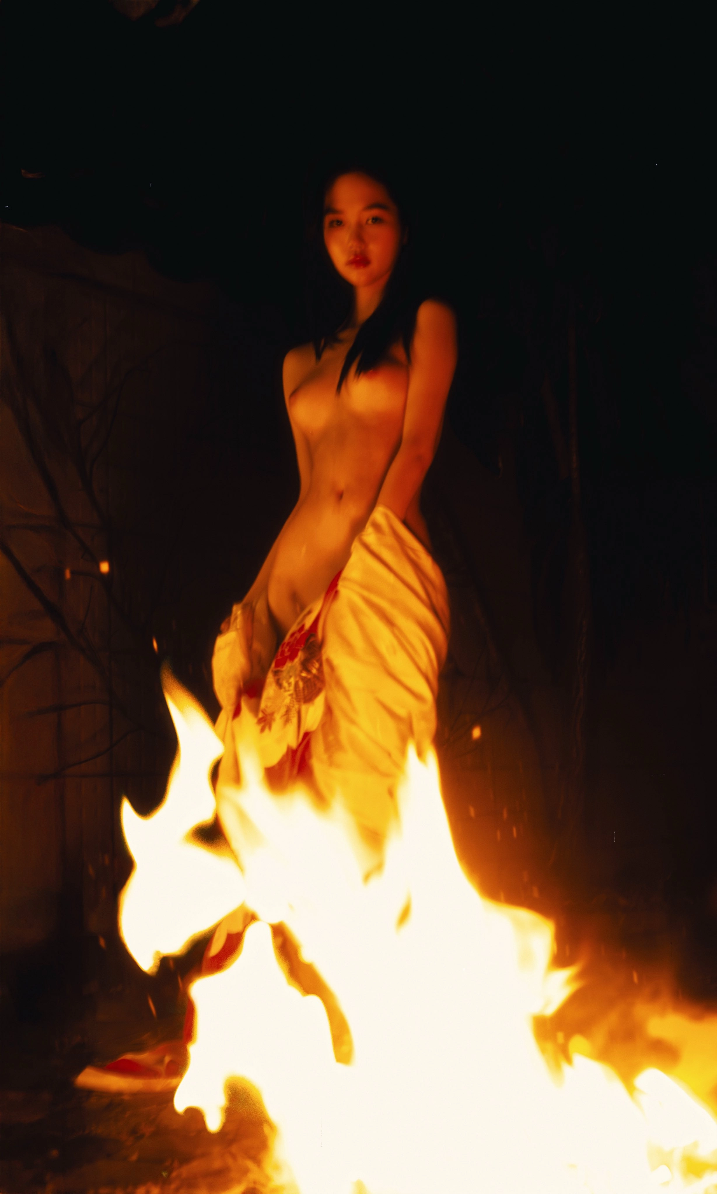 Women stand in front of the fire.