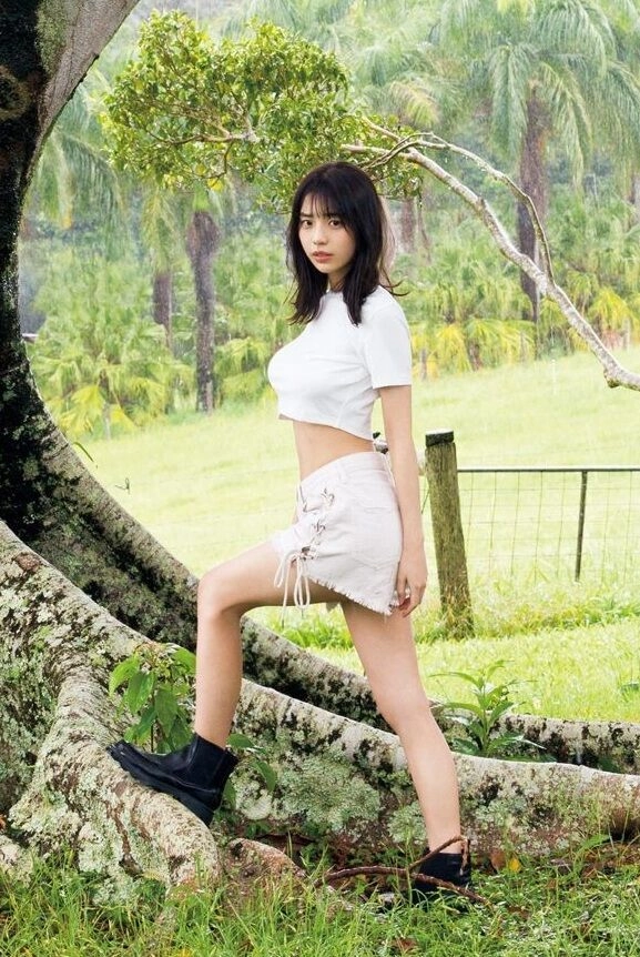 女人站在一棵树前。