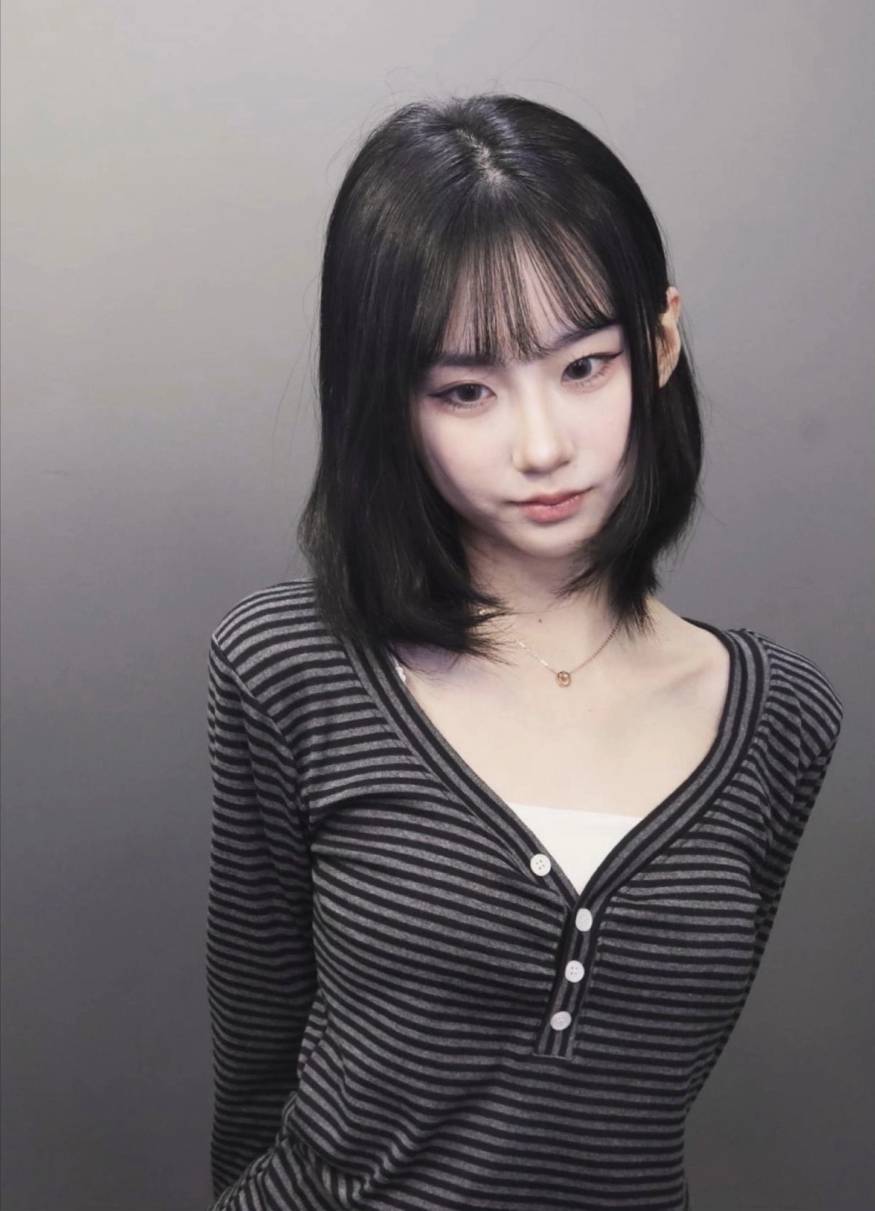 黑头发的女人和一条带有条纹的衬衫。