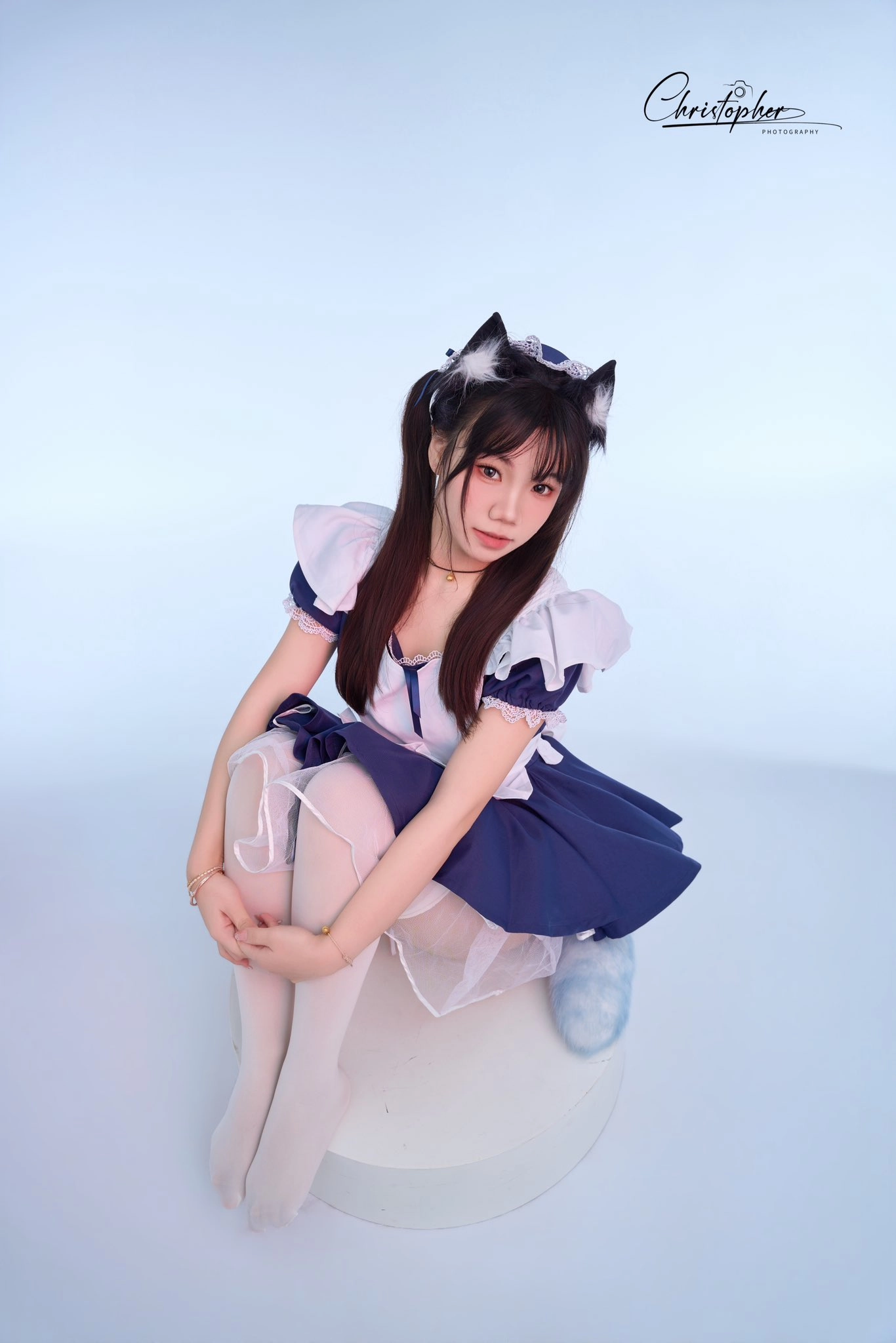 穿着女仆服装的女孩坐在一个白色的球上。