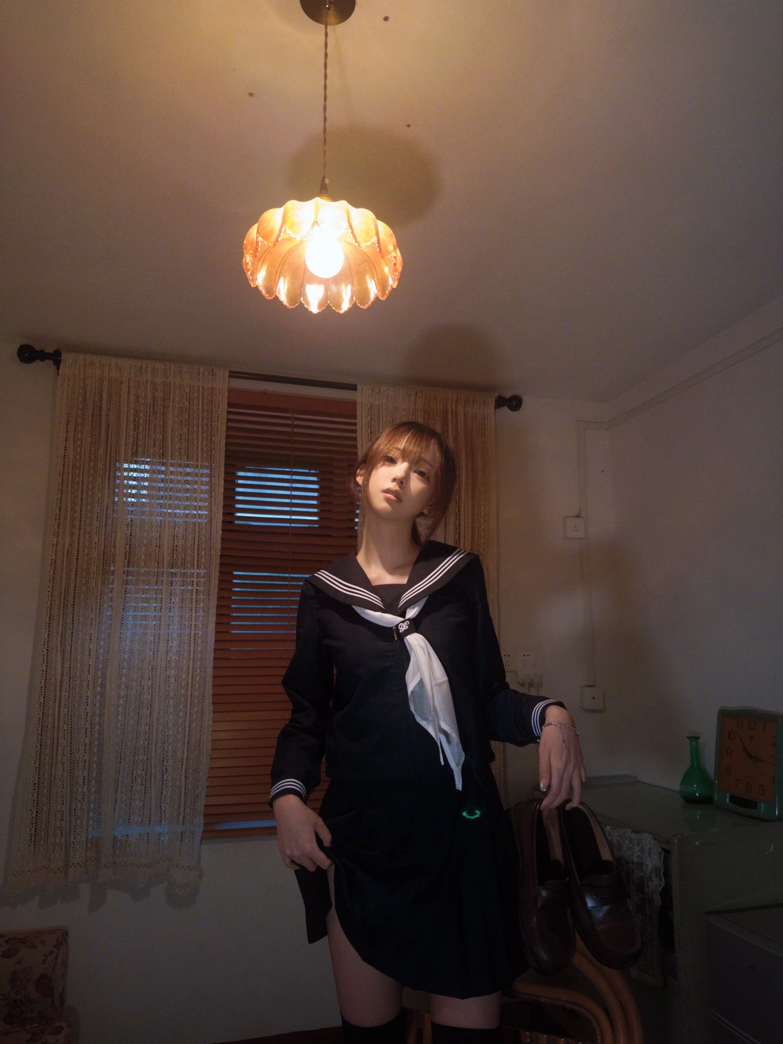 穿着黑色衣服的女人站在一盏灯下。