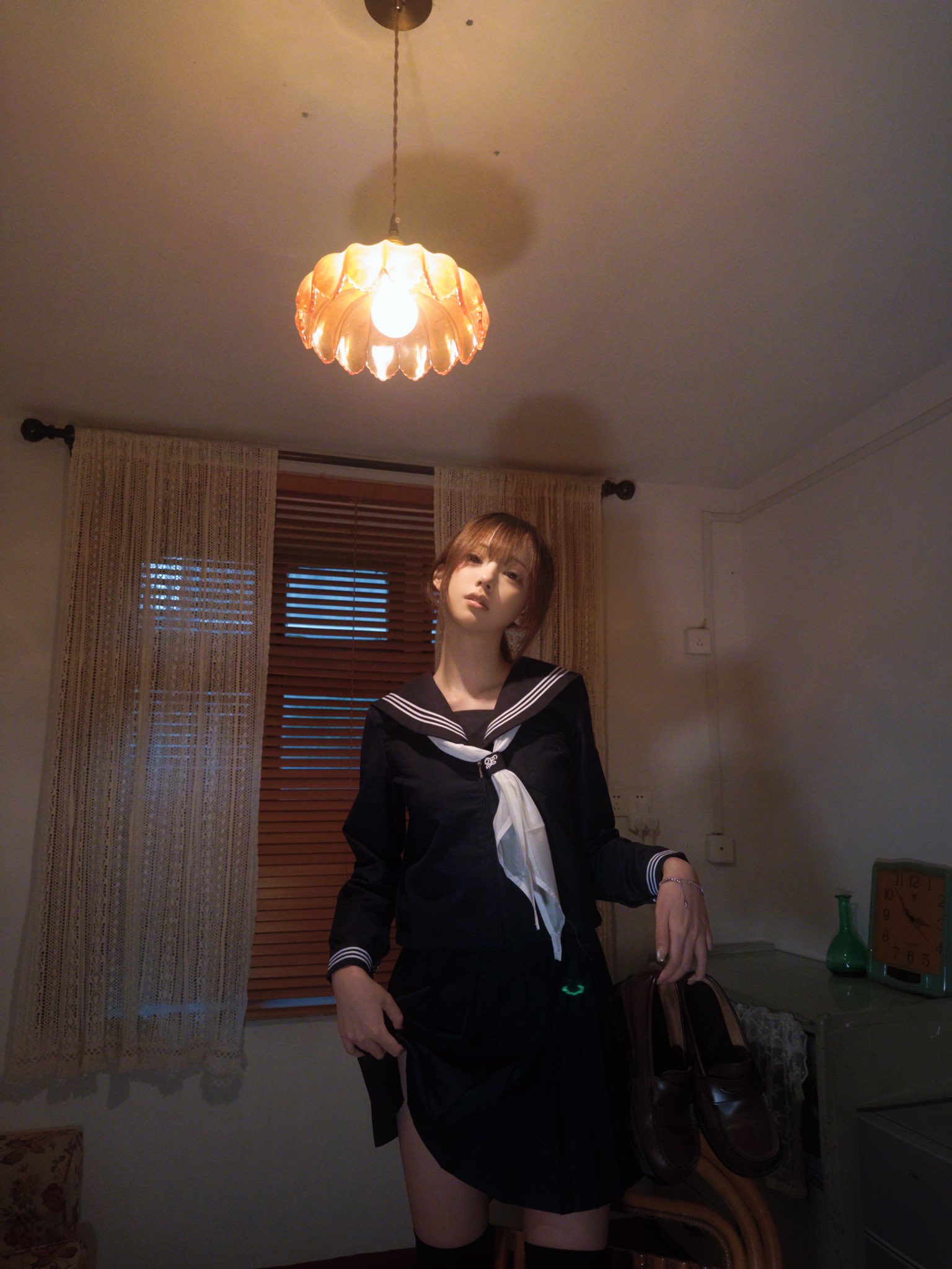 穿着黑色衣服的女人站在一盏灯下。