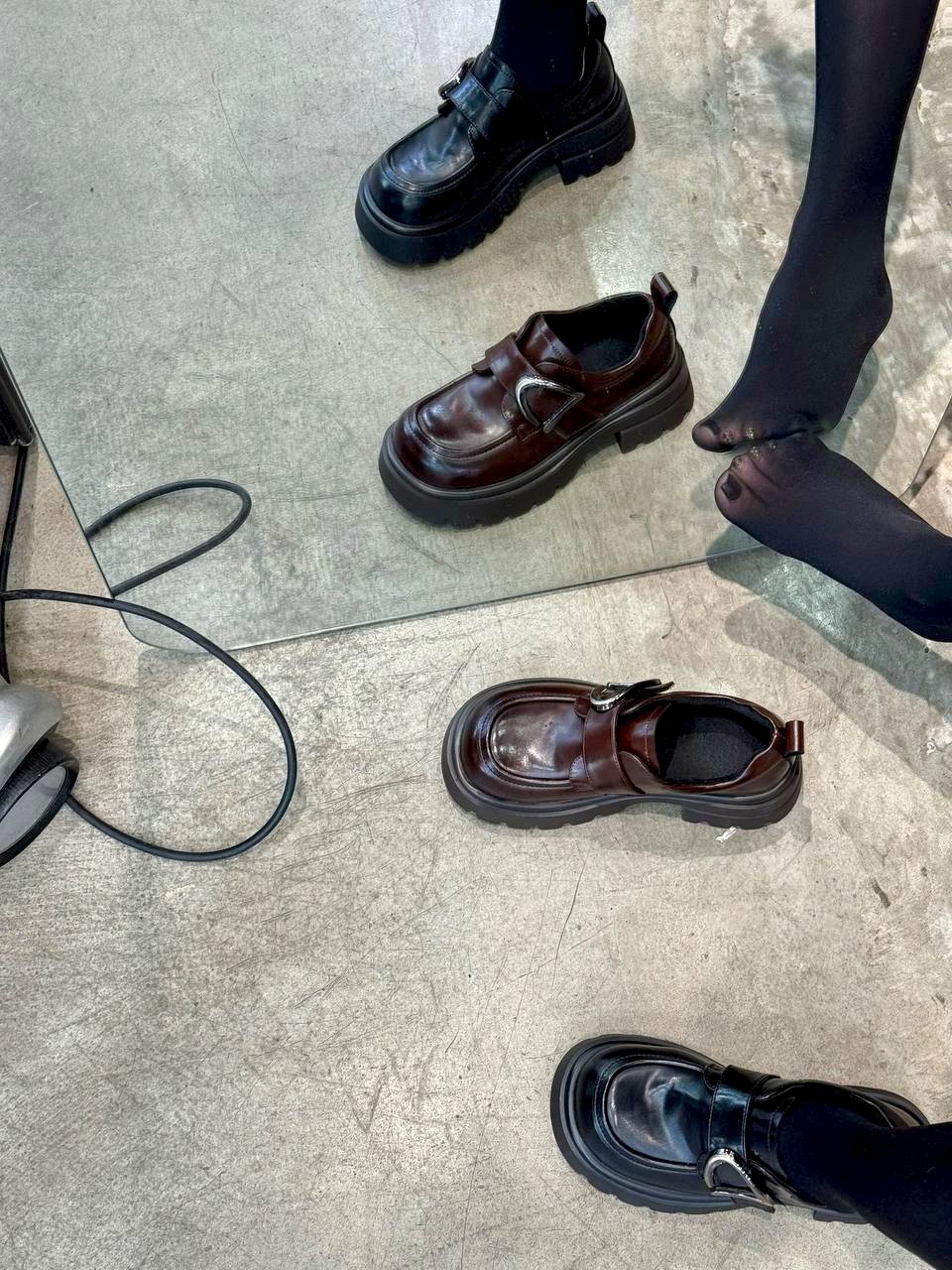 一双鞋子反映在镜子里。