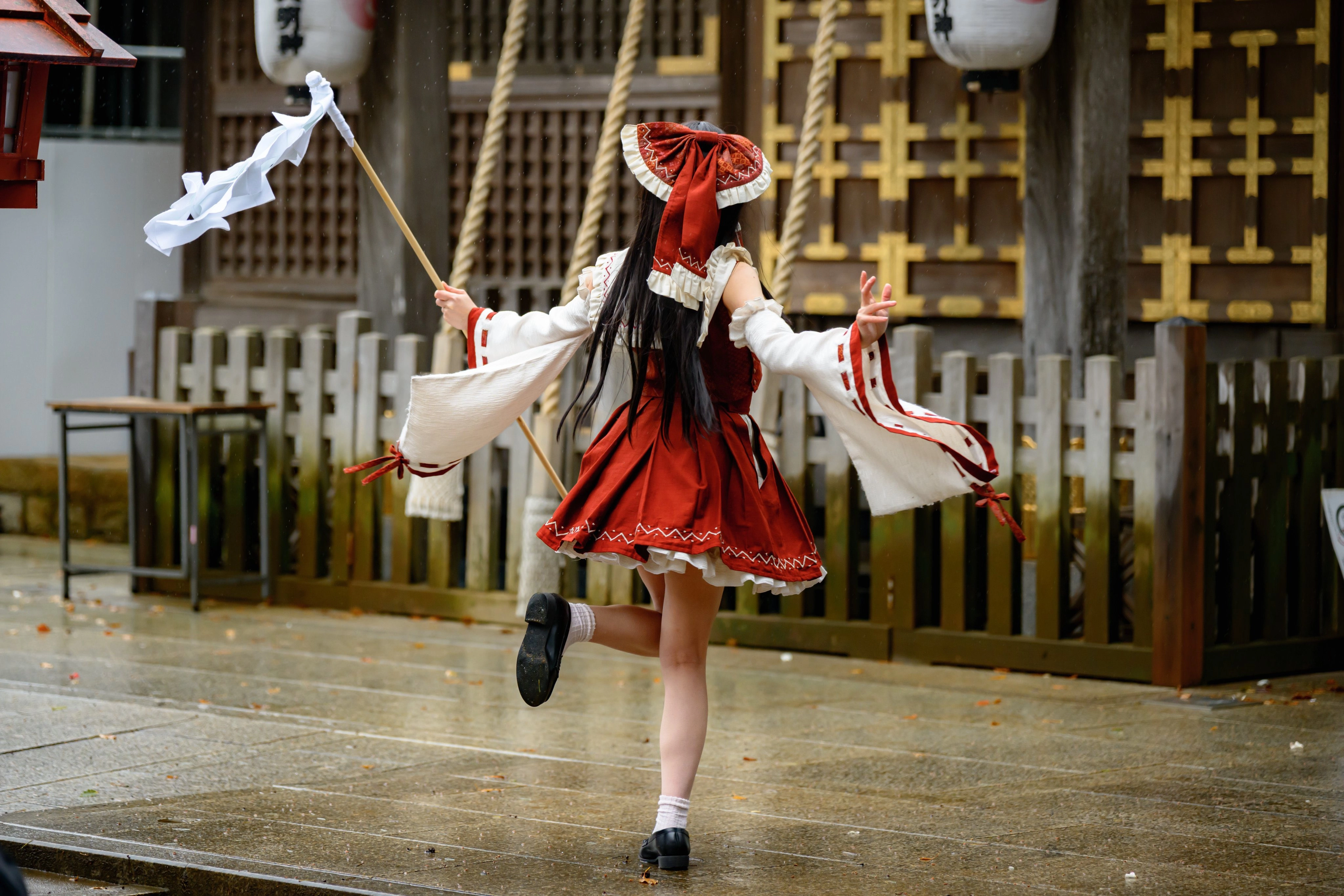 一位穿着红色裙子和白色帽子的妇女举着一面旗帜。