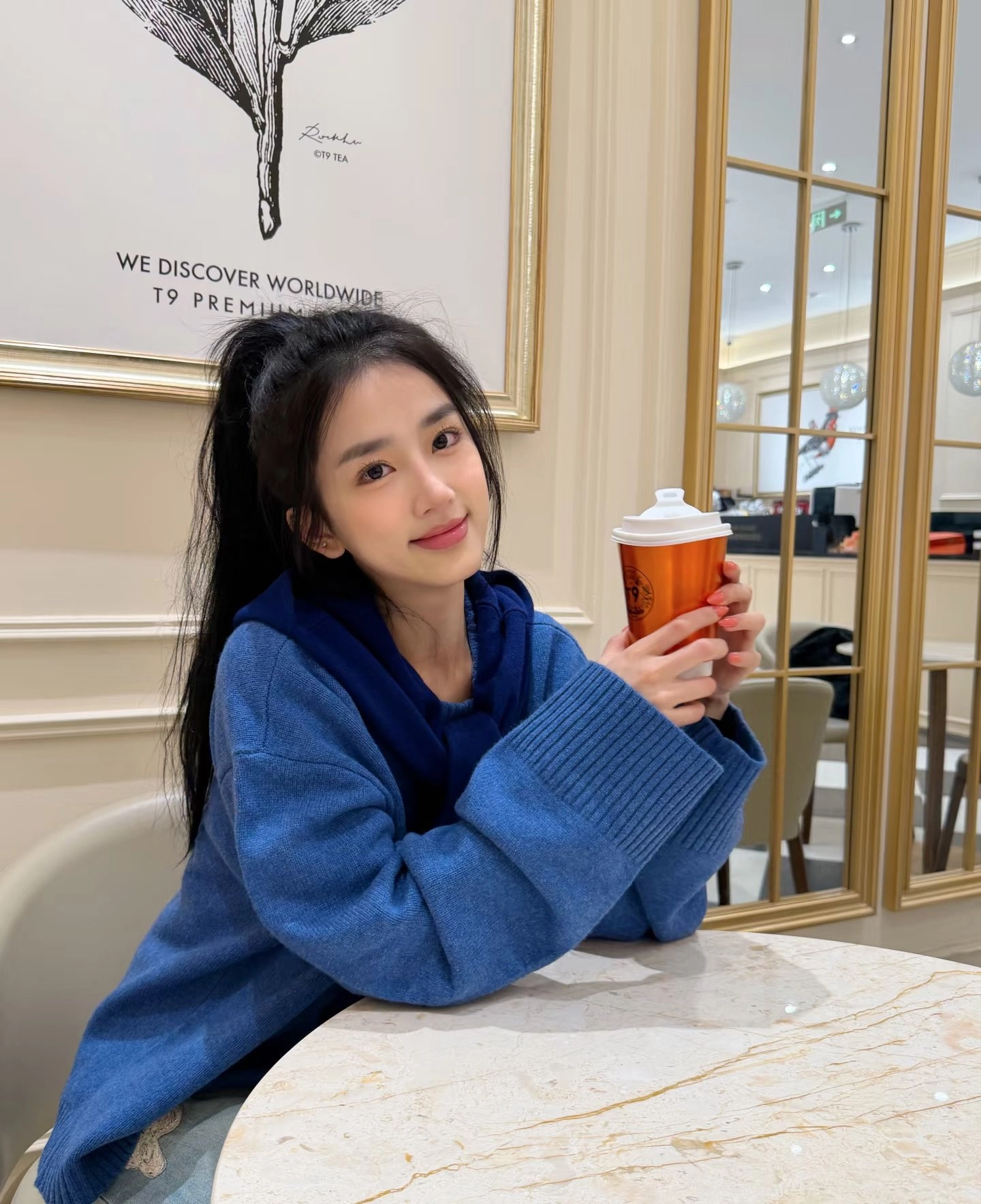 长头发的女人拿着一杯咖啡。