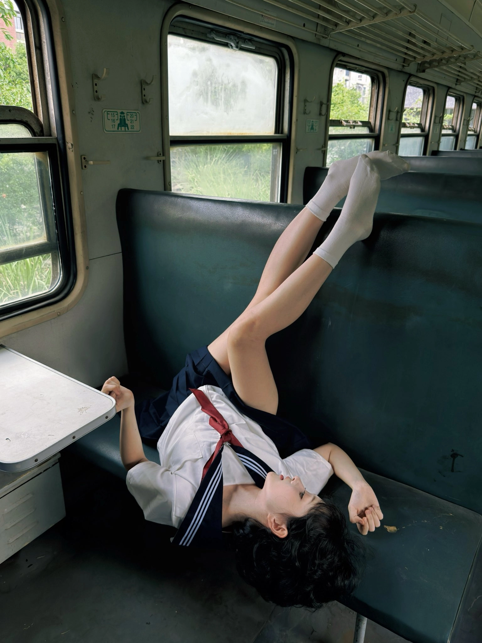 女人躺在一个凳子上,她的腿在空中。