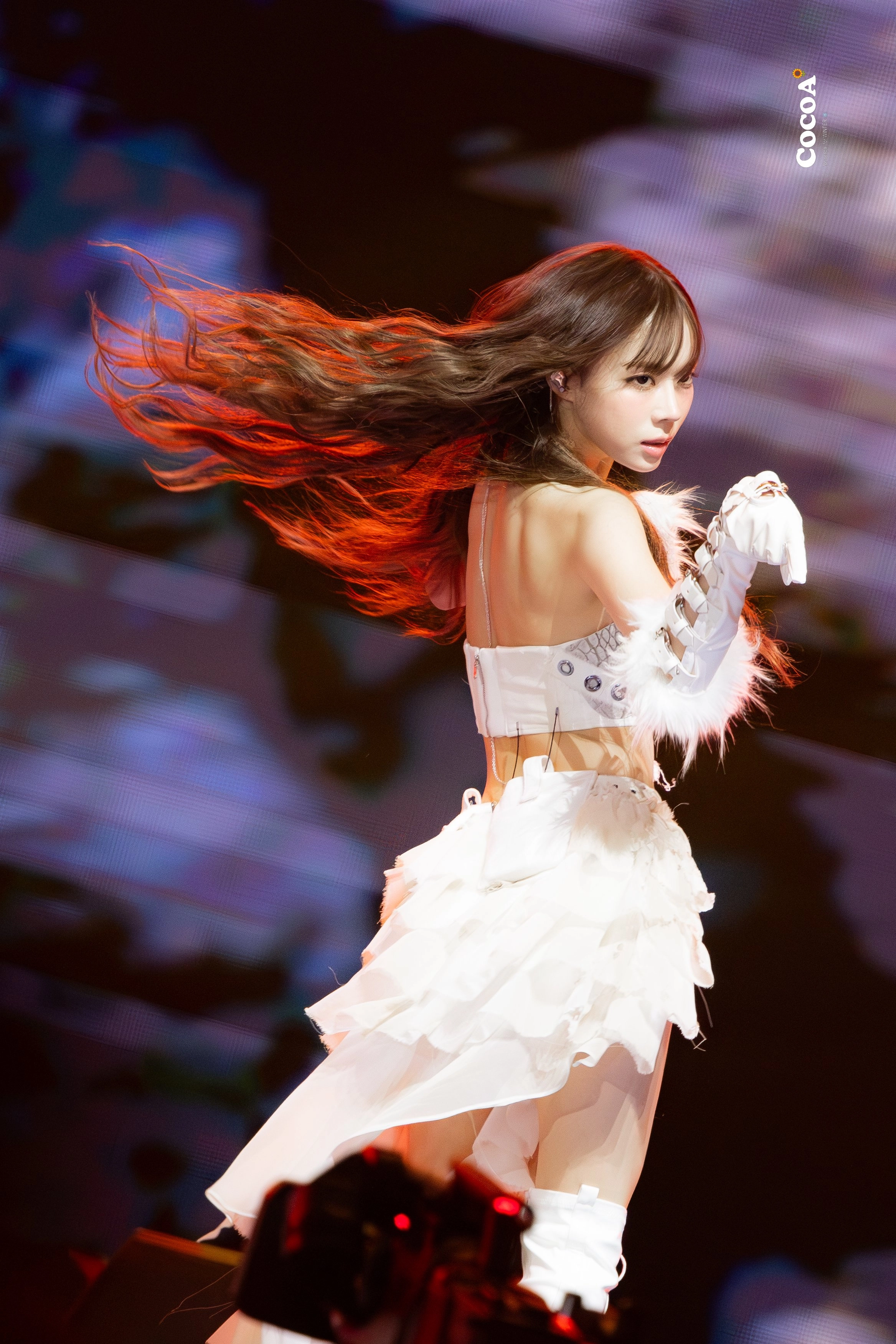 红头发和白衣的女人在舞台上表演。