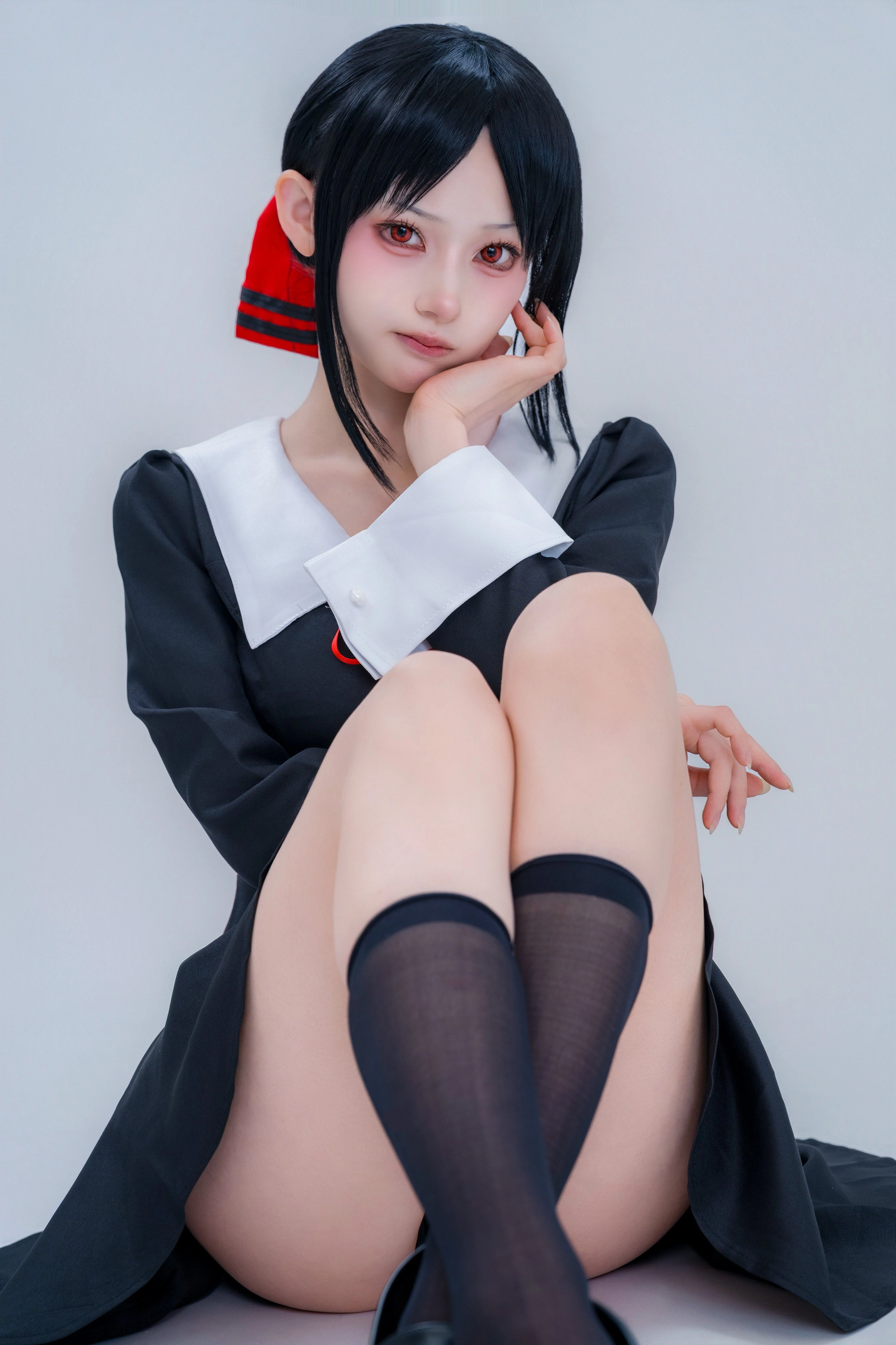 女人穿着一件黑白的裙子,有一条红色的弓。