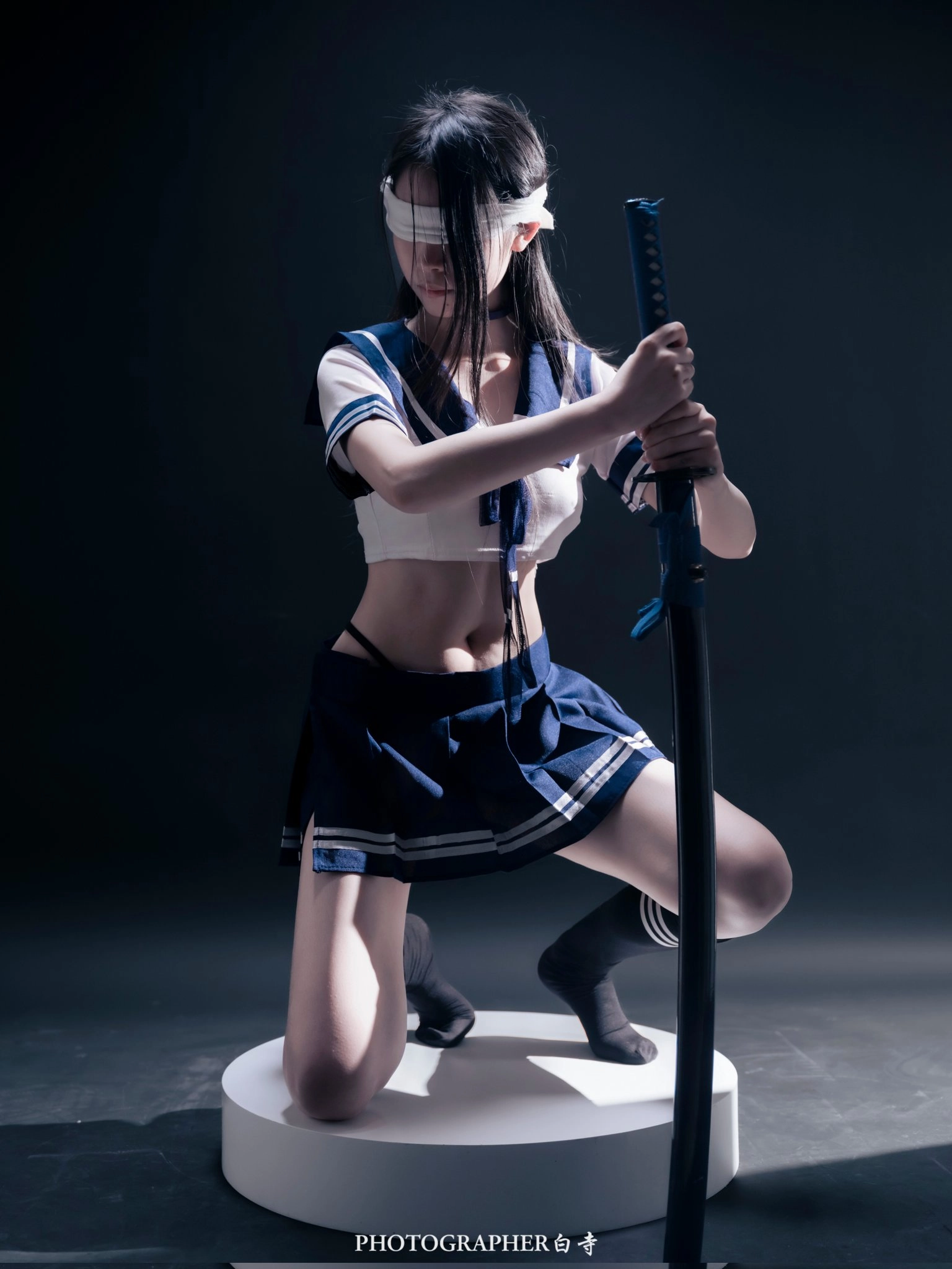 A woman wearing a sword.