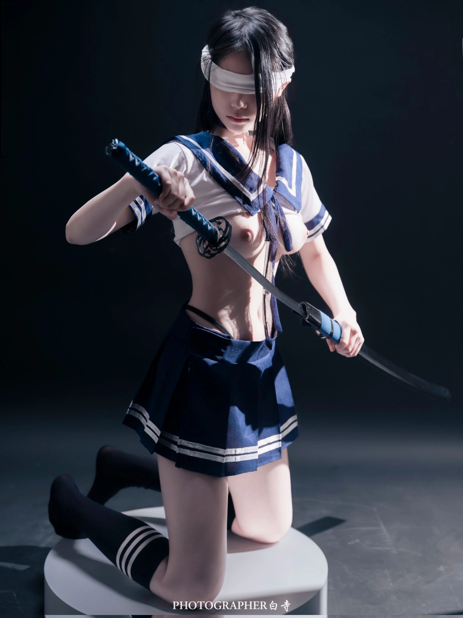 A woman wearing a sword.