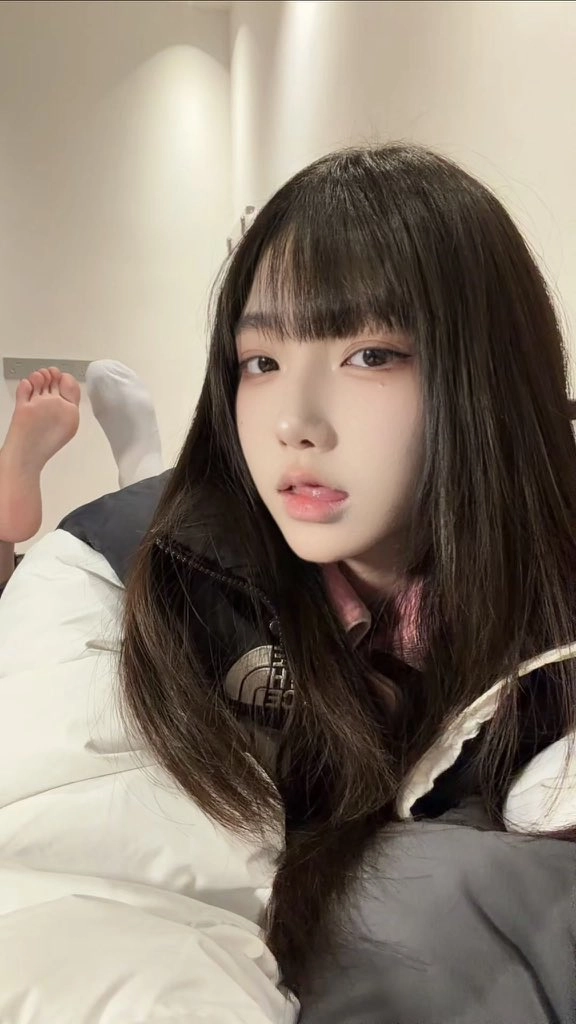 女孩穿着一件黑白的夹克和一件粉红色的衬衫。