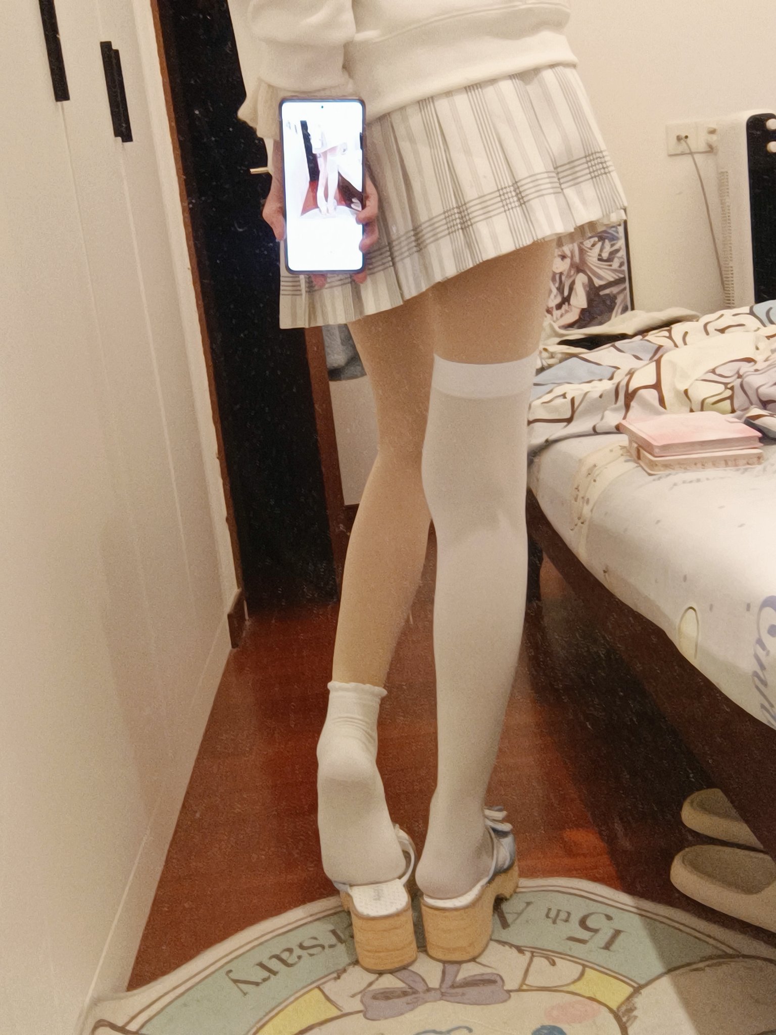 穿着白色裙子和白色袜子的女人站在镜子前。