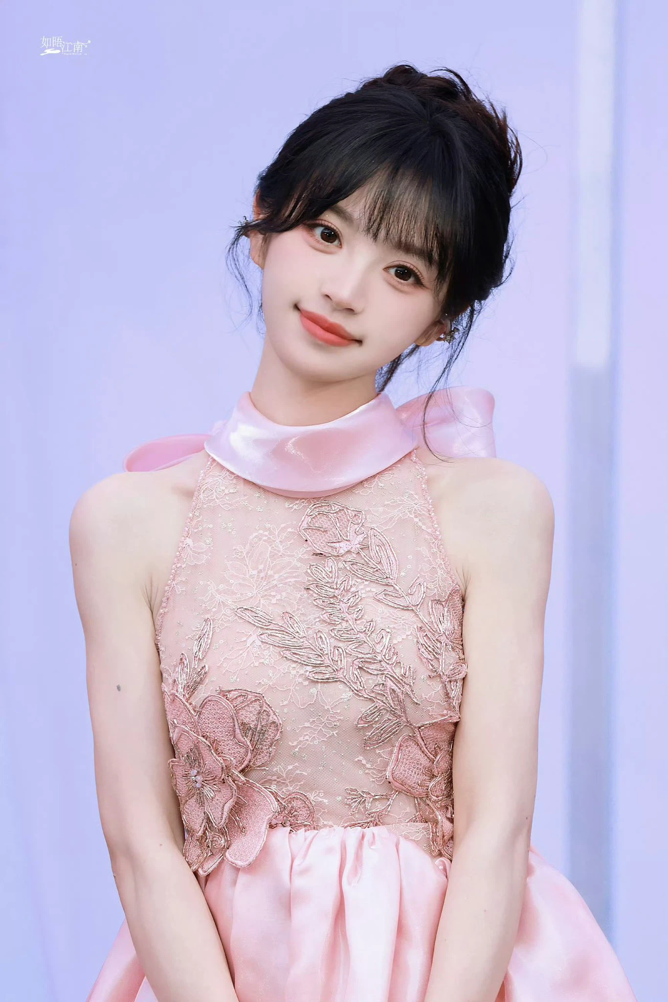 女人穿着粉红色的裙子,头上有弓。