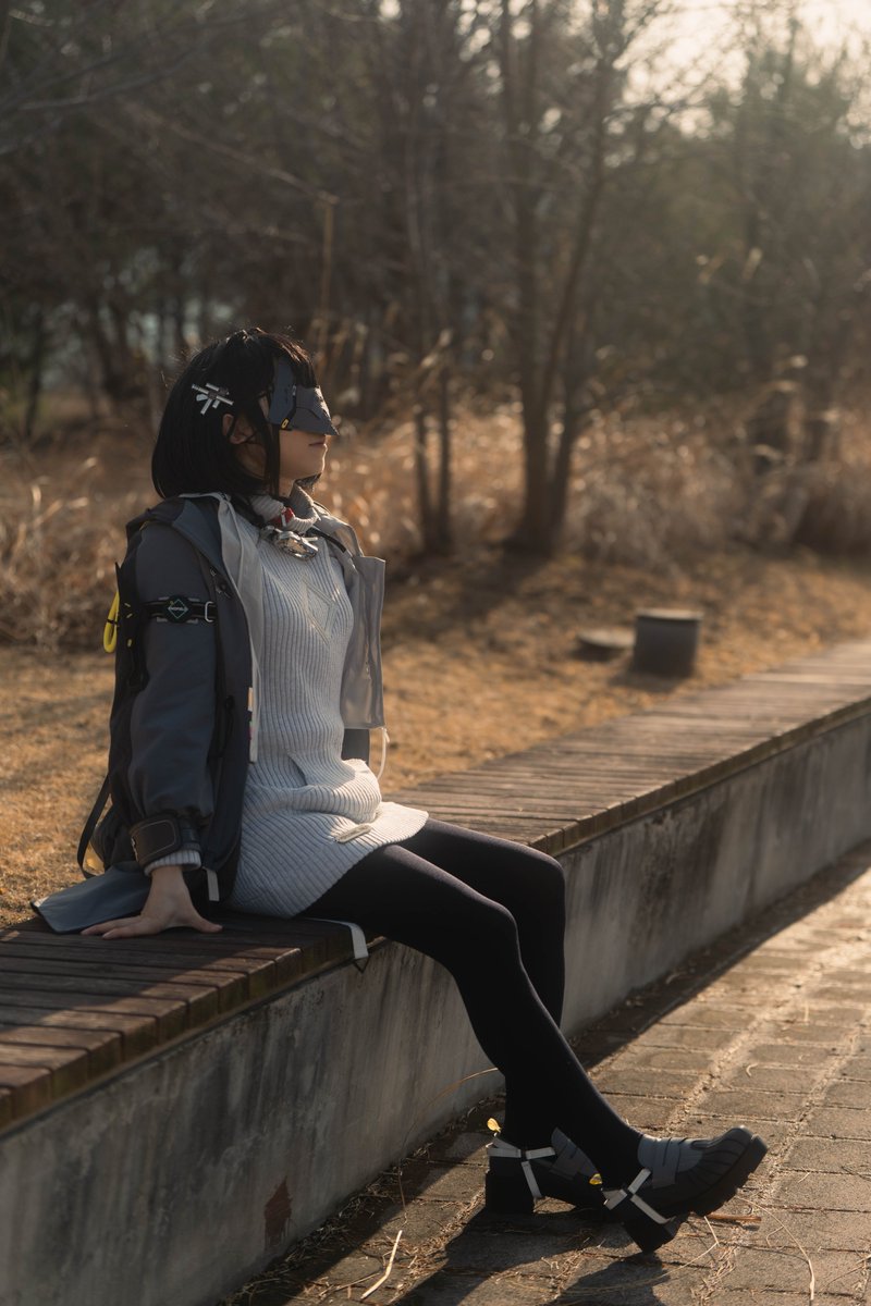 戴着面具和灰色夹克的女人。