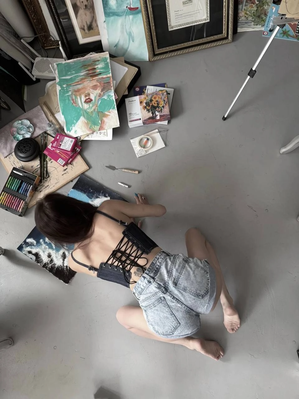 女人在地板上画一幅画。