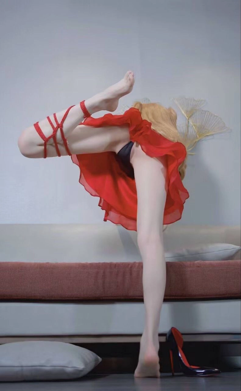 穿着红色衣服的女人站在沙发上。