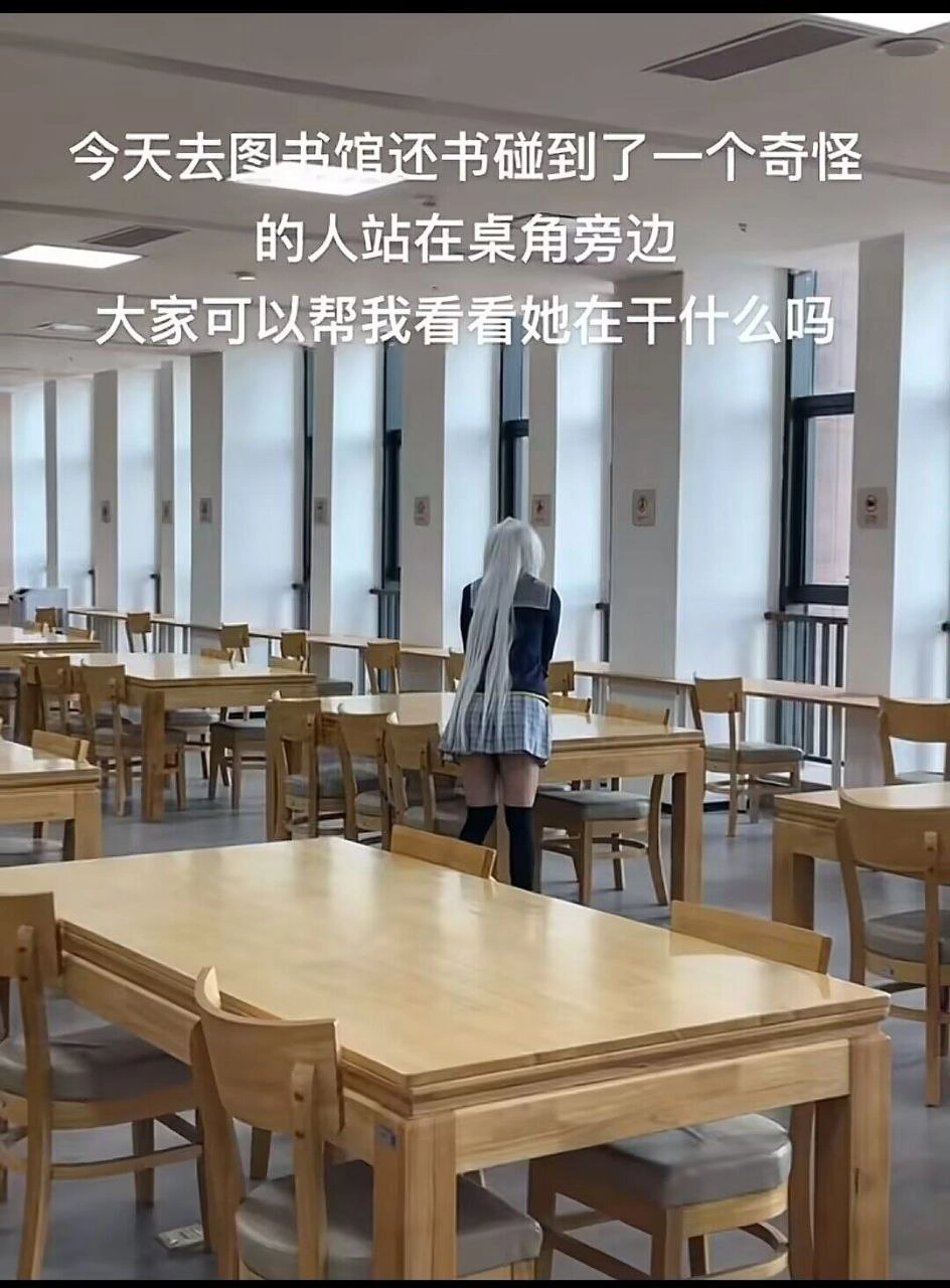 一位穿着蓝色和白色衣服的女人站在房间里,里面有很多桌子和椅子。