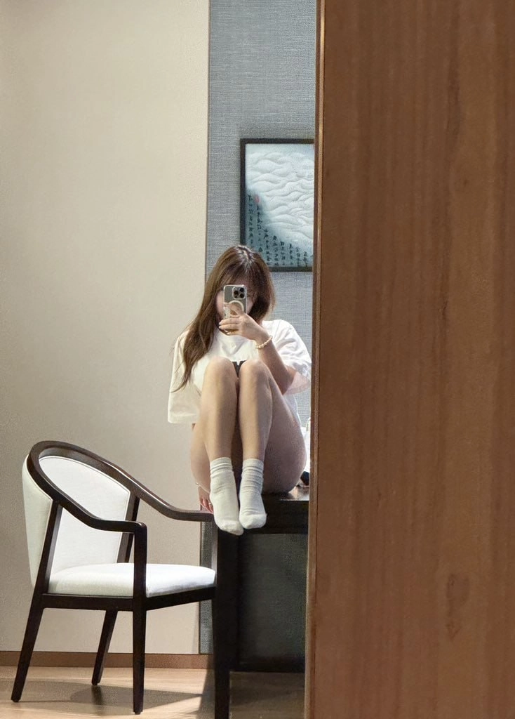 女人在镜子前拍自拍。