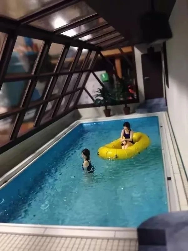 两个女人在游泳池里,穿着黄色的架子,另一个穿着黑色的比基尼。